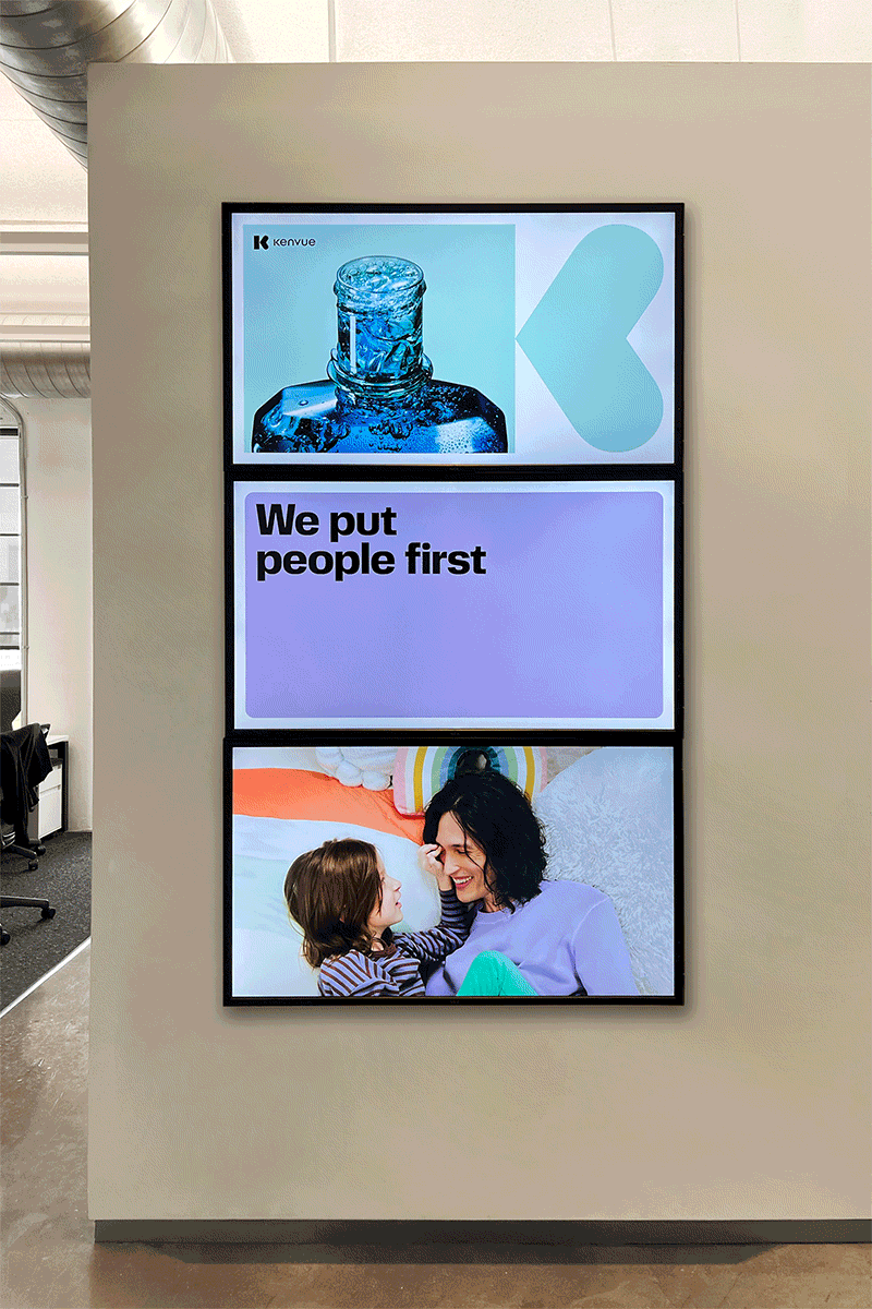 Digital display with three sections: the top showing a bottle of water, the middle with the text 'We put people first', and the bottom showing a woman and a young girl smiling and touching noses.