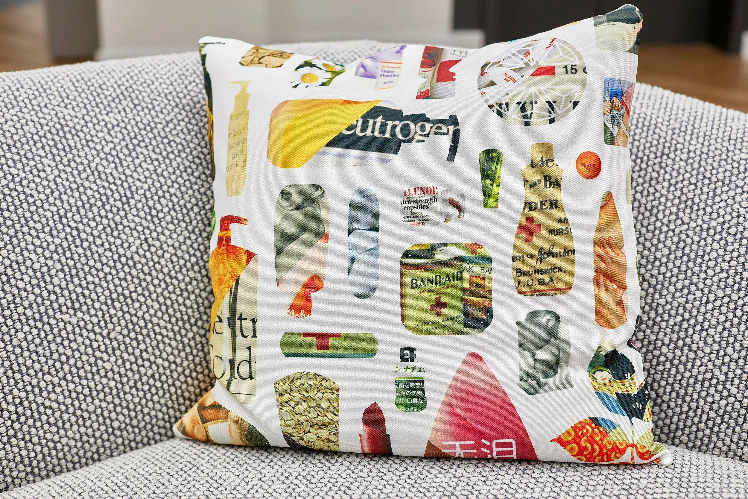 A wrapped gift with a colorful collage of vintage and medical-themed illustrations and labels, sitting on a textured gray and white fabric surface.