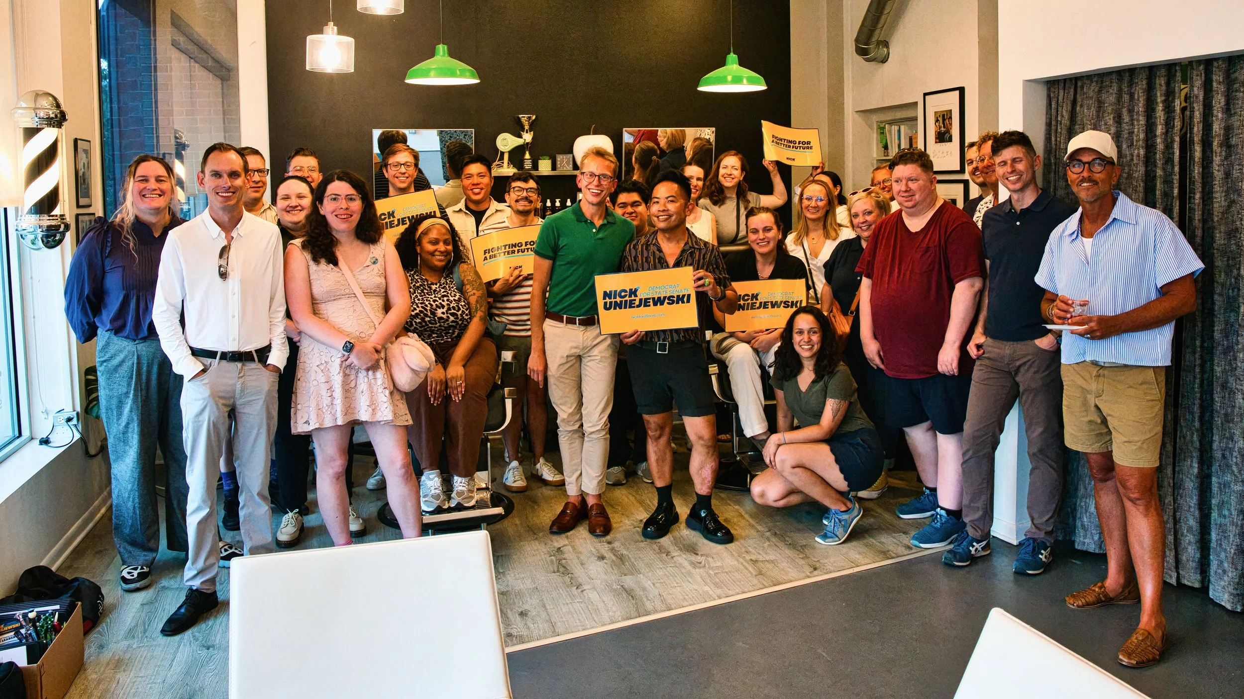Group photo of smiling folks holding Nick campaign signs