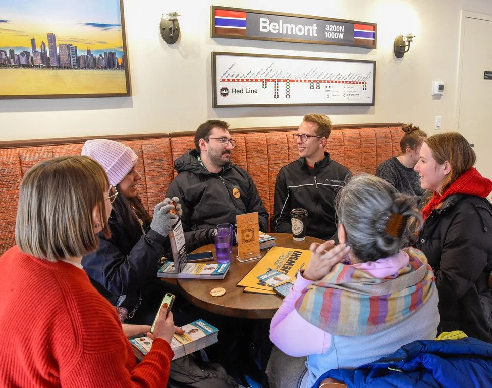 Nick speaks at a coffee shop with a group of supporters