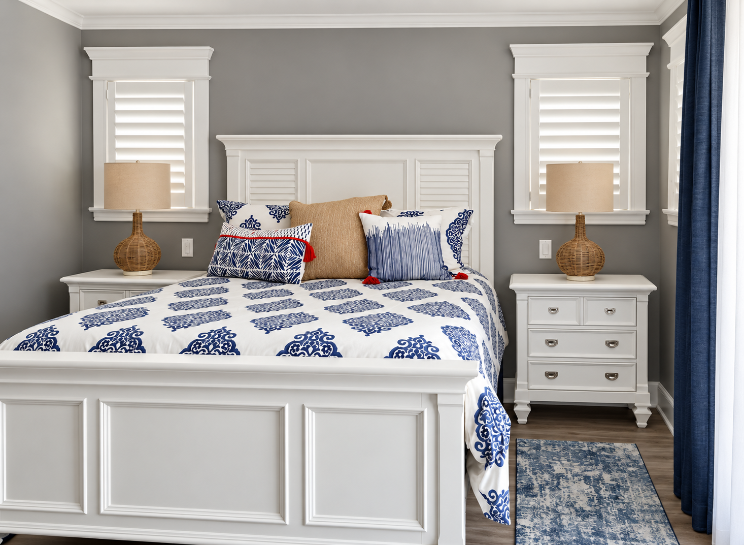 Bedroom with gray walls and white plantation shutters in the renovated Sea Isle City duplex