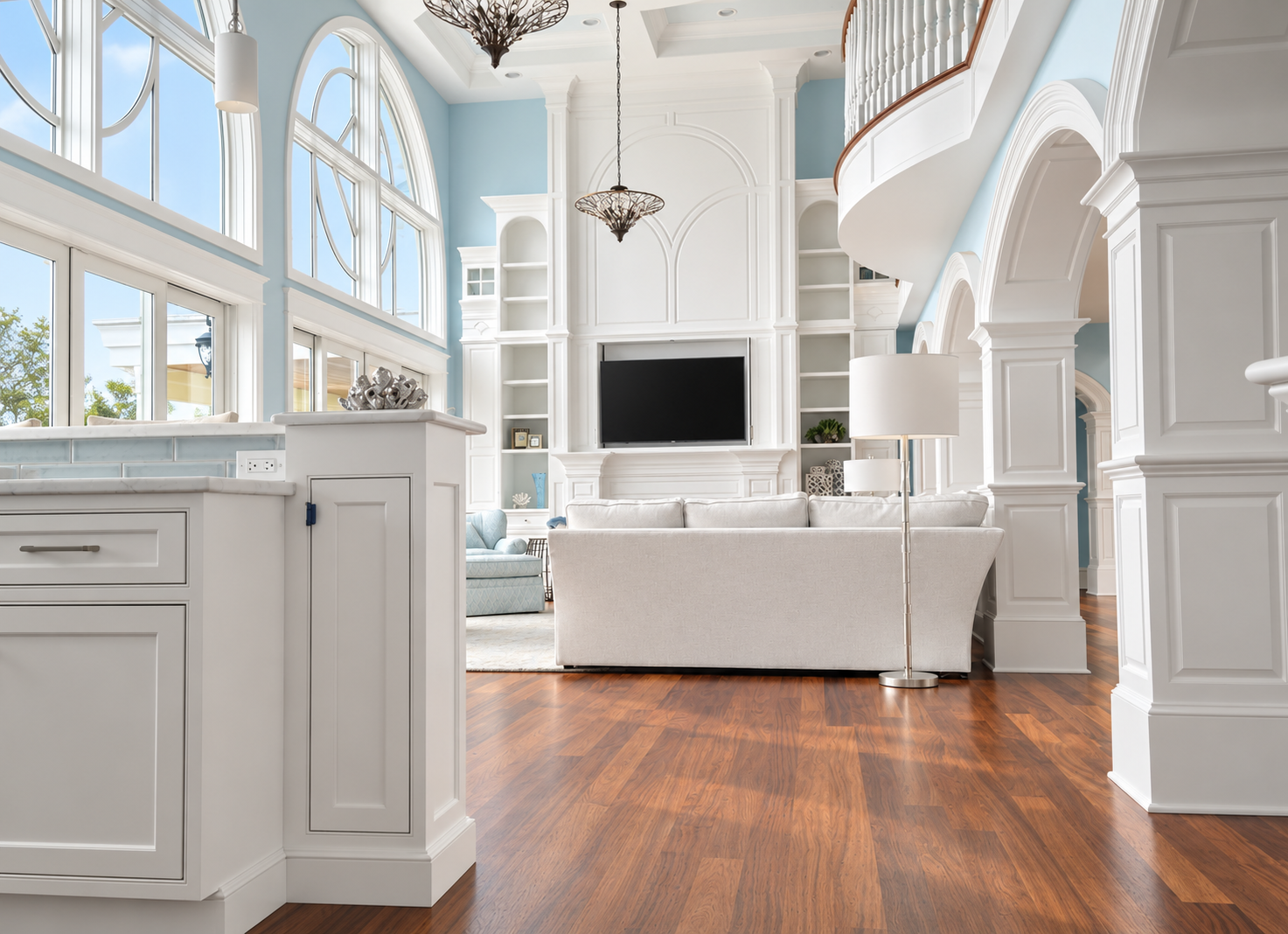 Double-height great room with tall windows and custom millwork in a new Avalon, NJ home