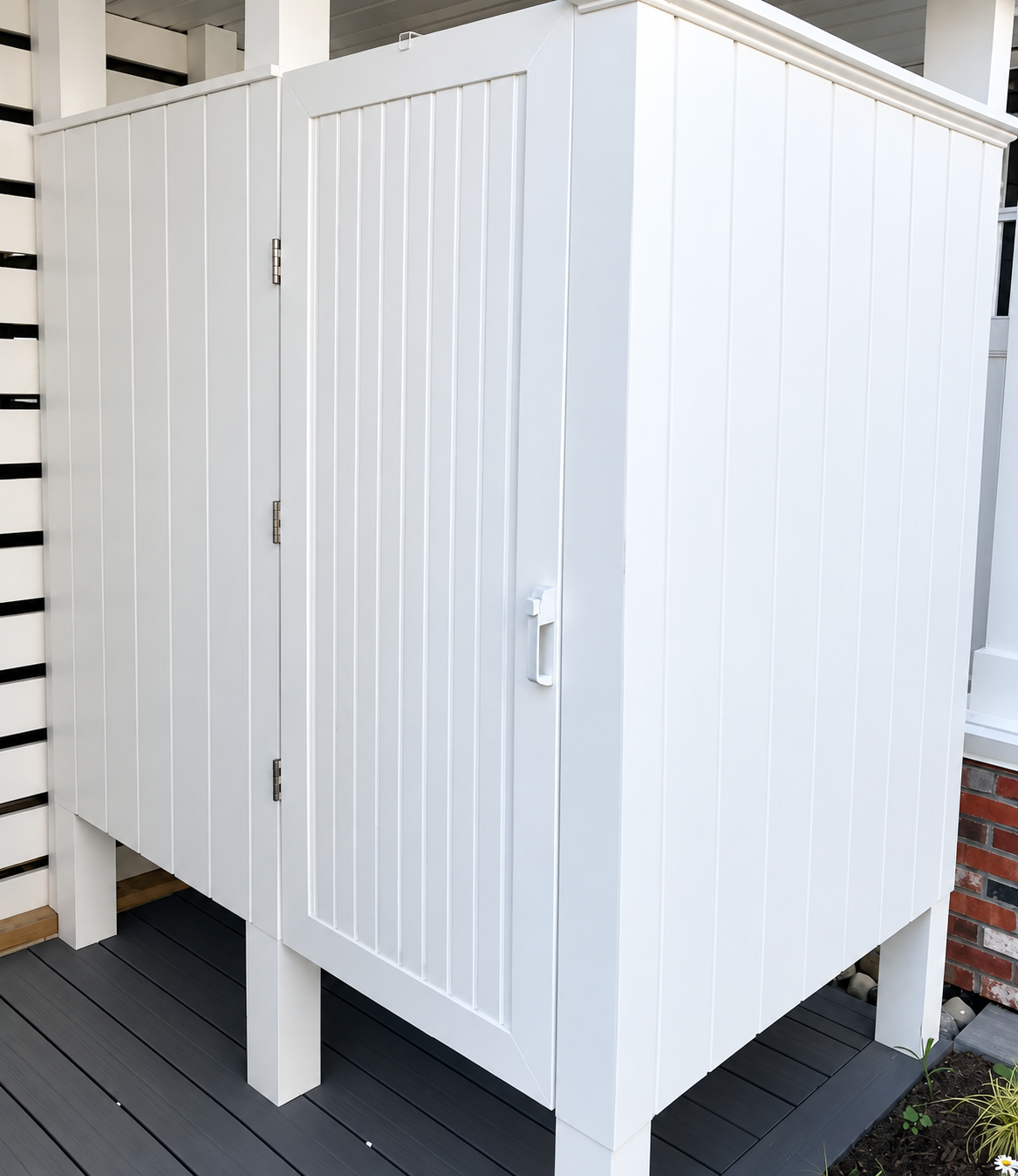 Outdoor storage enclosure with white beadboard doors at the renovated Sea Isle City duplex
