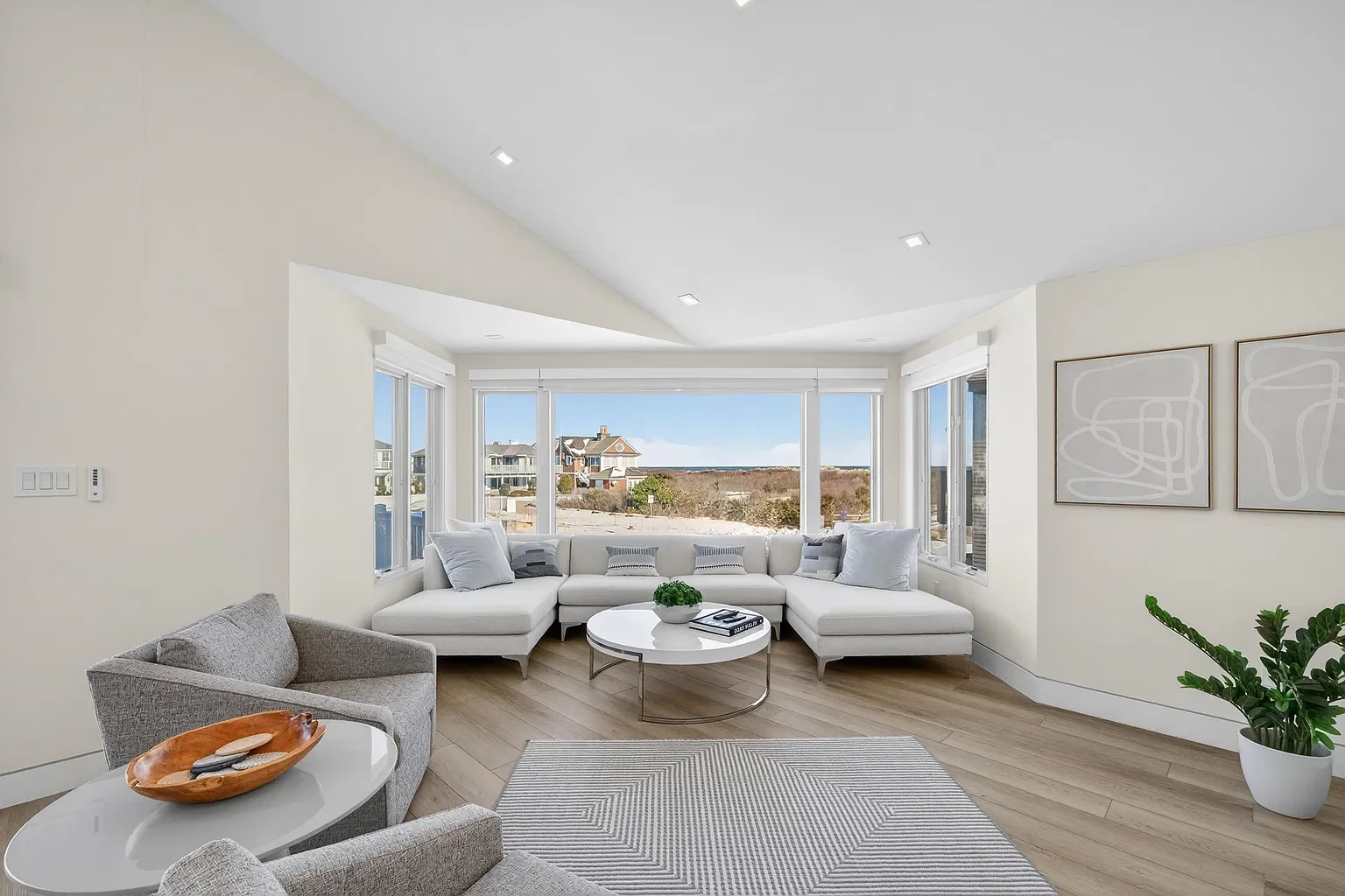 Renovated living room with large windows and new flooring, 107 116th St, Stone Harbor, NJ
