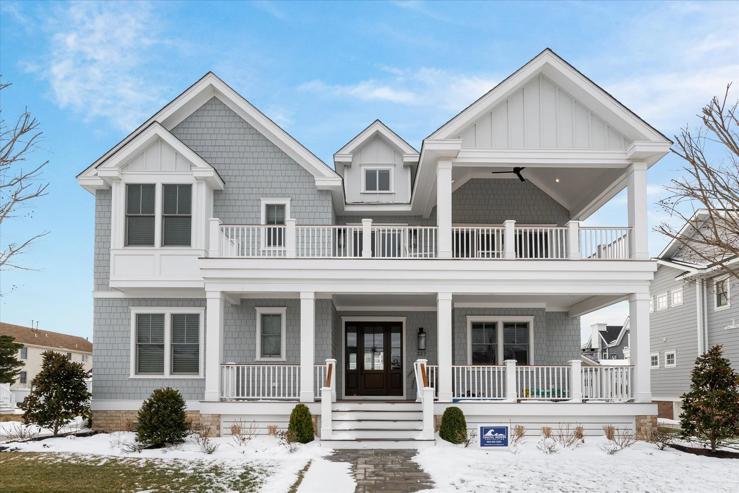 Shingle-style new custom home with double front porches at 227 107th St, Stone Harbor, NJ
