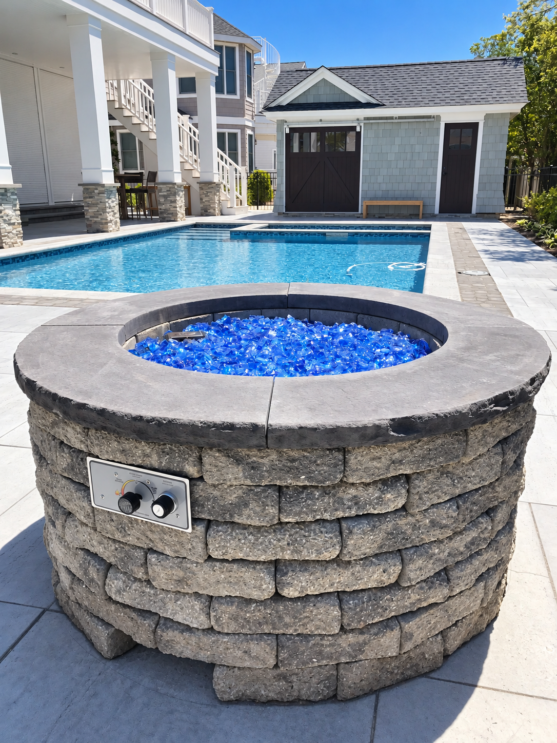 Fire pit with blue fire glass beside the pool, Stone Harbor NJ