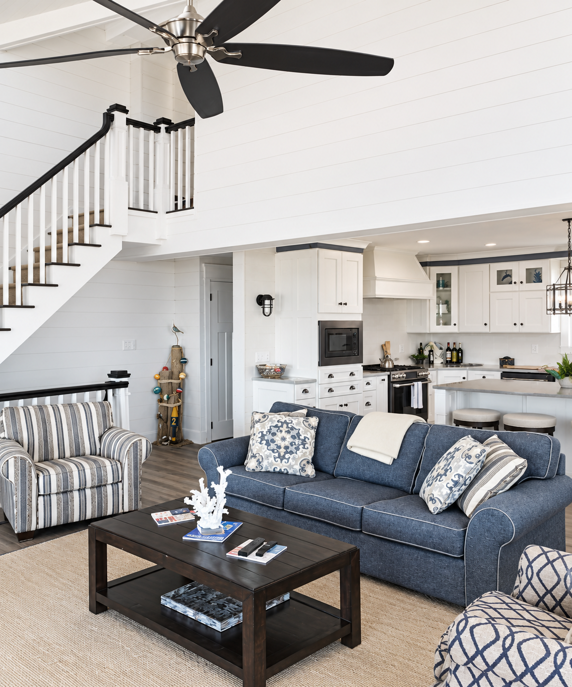 Open living room and kitchen with shiplap walls in the renovated Sea Isle City duplex