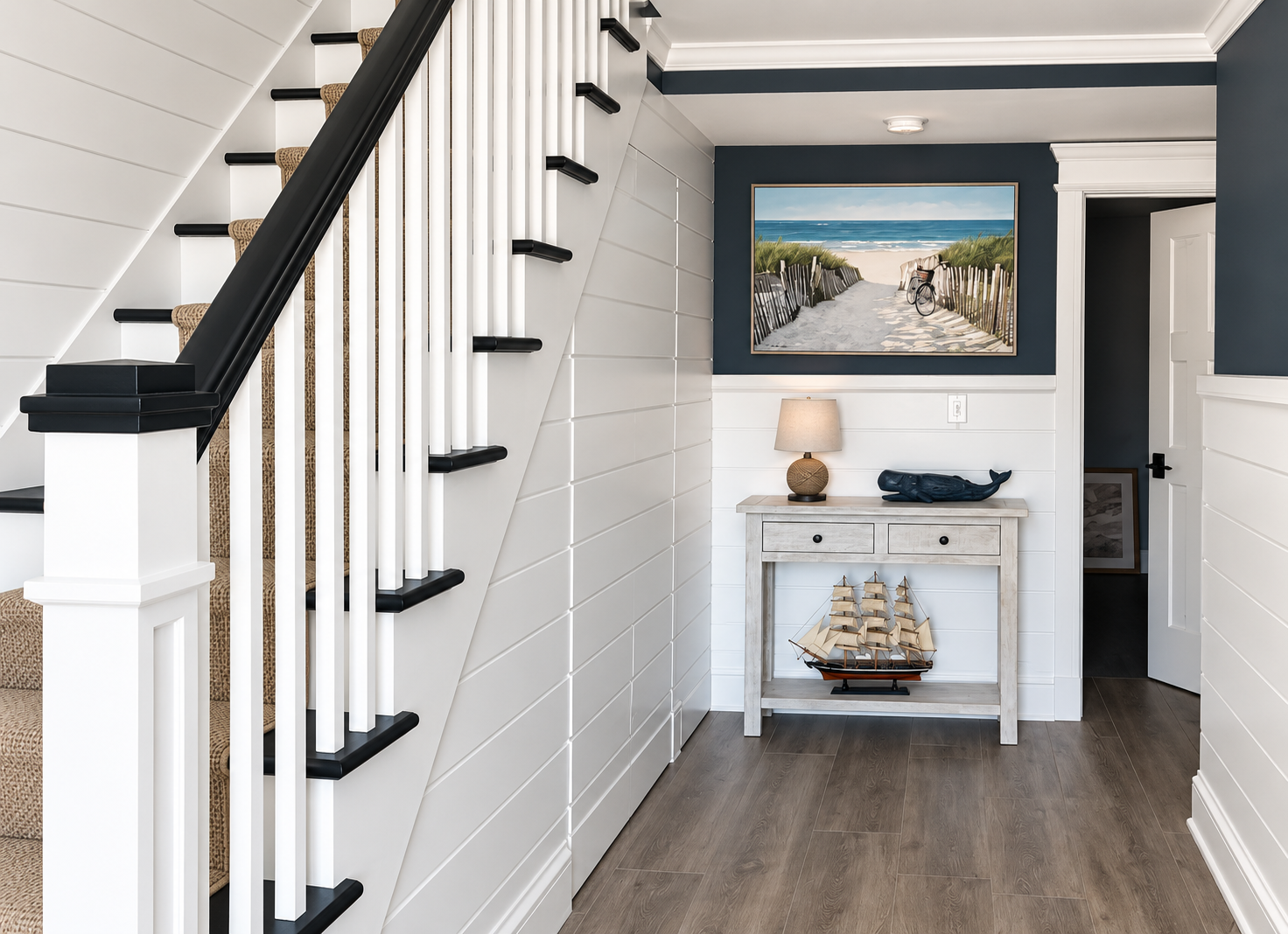 New staircase and entry hall with shiplap walls in the renovated Sea Isle City duplex