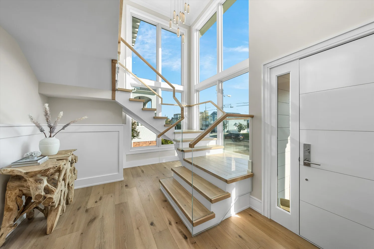 Custom staircase with glass railing in a CMC home on 57th Street, Avalon