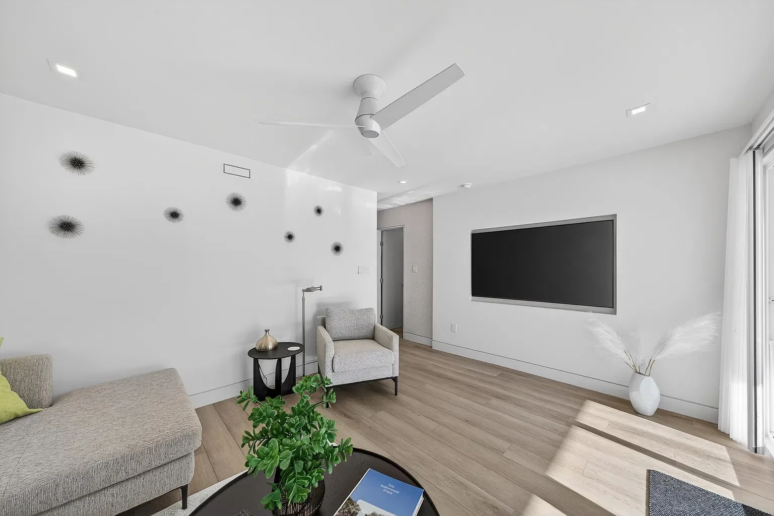 Renovated living room with a wall-mounted TV, 107 116th St, Stone Harbor, NJ