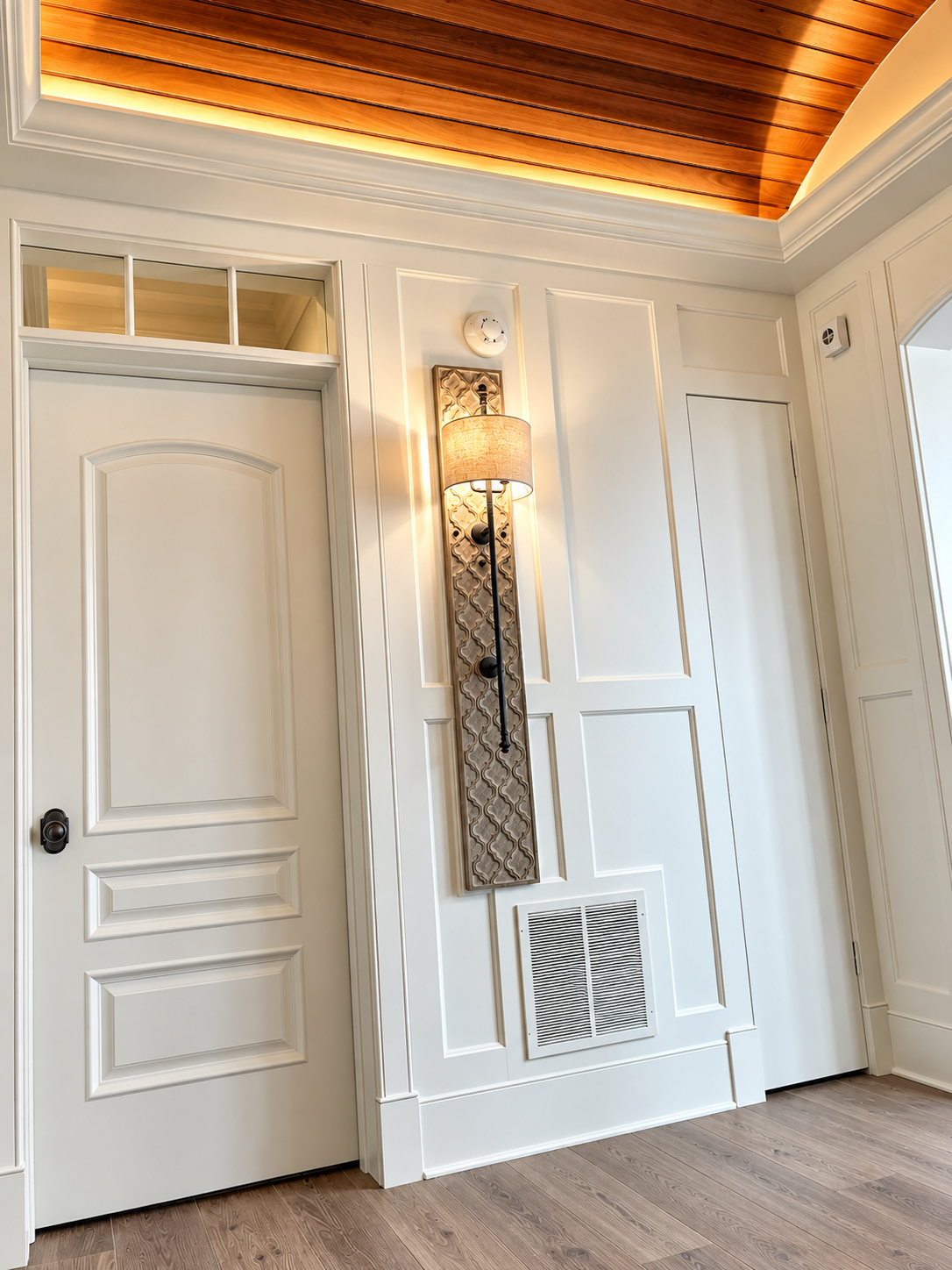 Hallway with paneled walls and wall sconce, Stone Harbor NJ custom home