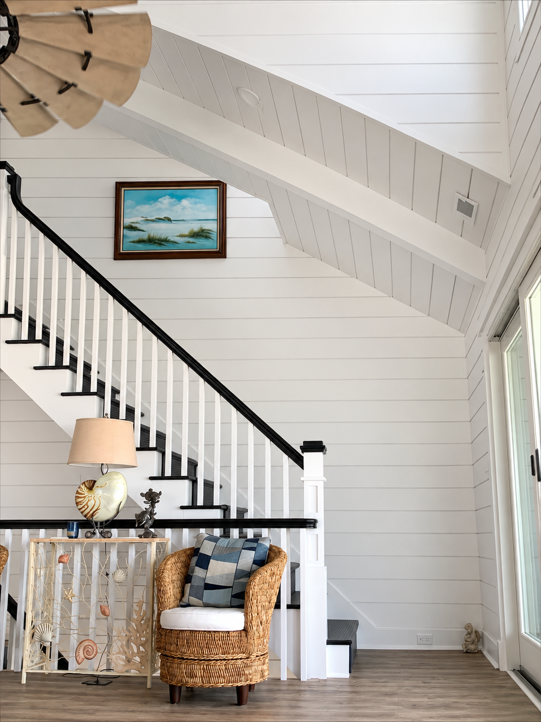 Staircase under a vaulted shiplap ceiling in the renovated Sea Isle City duplex
