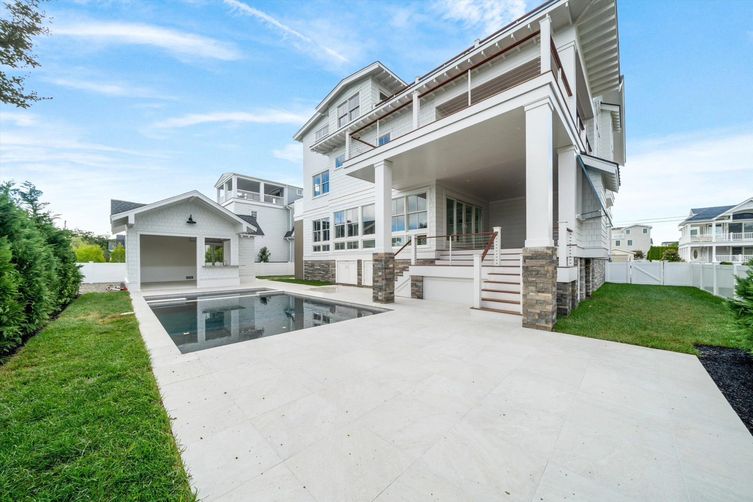 Custom shingle-style home with gunite pool, spa and pool house built by Coastal Modern Construction at the Jersey Shore