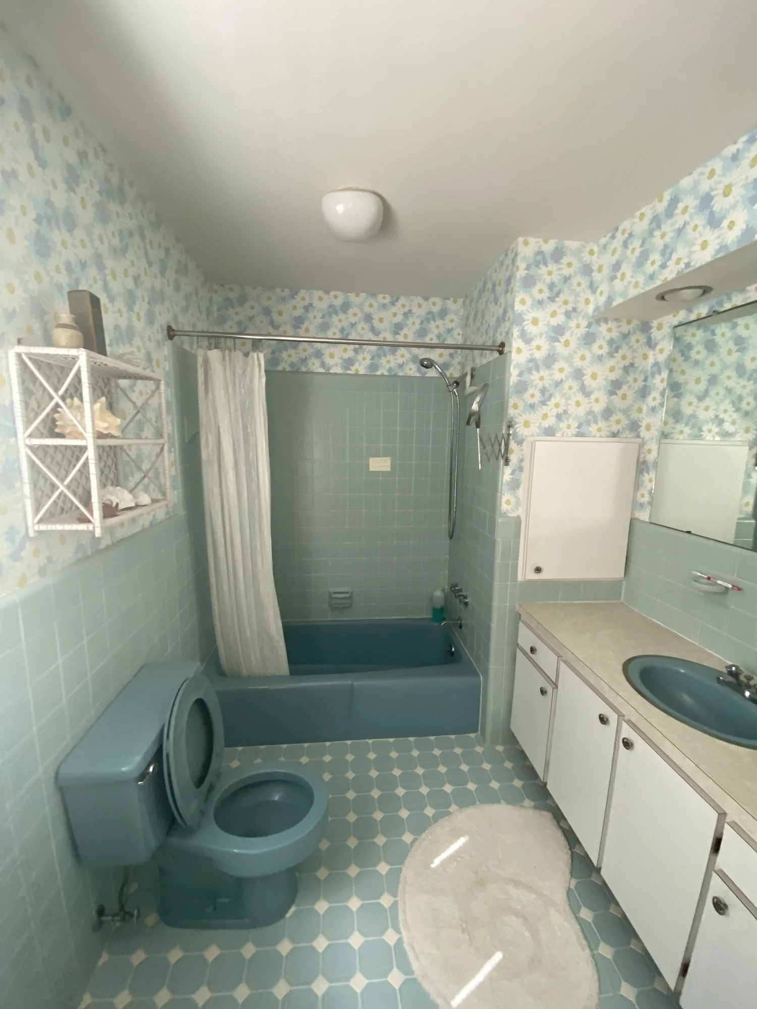 Before: dated bathroom with old tile and wallpaper, 107 116th St, Stone Harbor, NJ