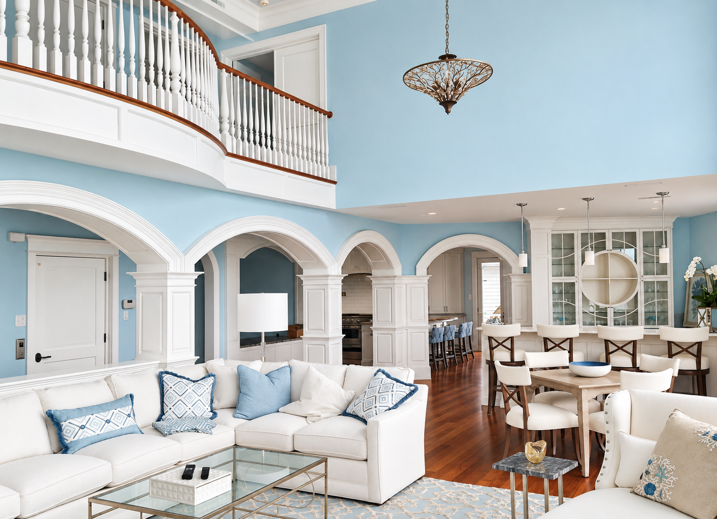 Double-height great room with an upper balcony and arched openings in a new Avalon, NJ home