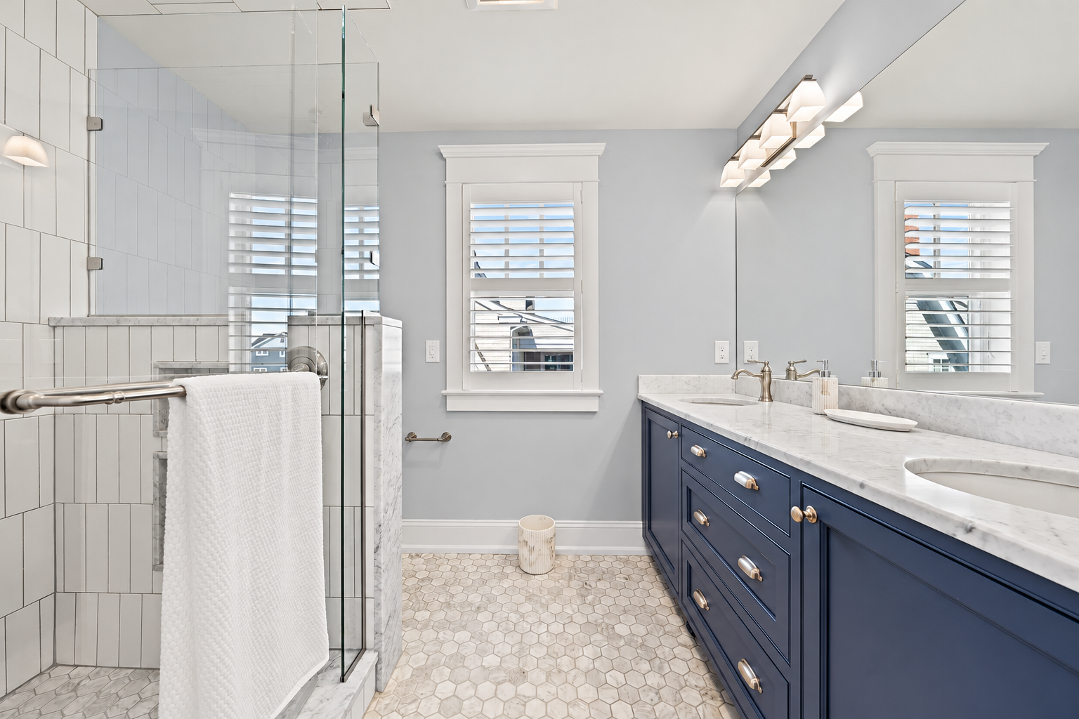 Bathroom with a navy double vanity and glass shower, 213 57th St, Avalon, NJ