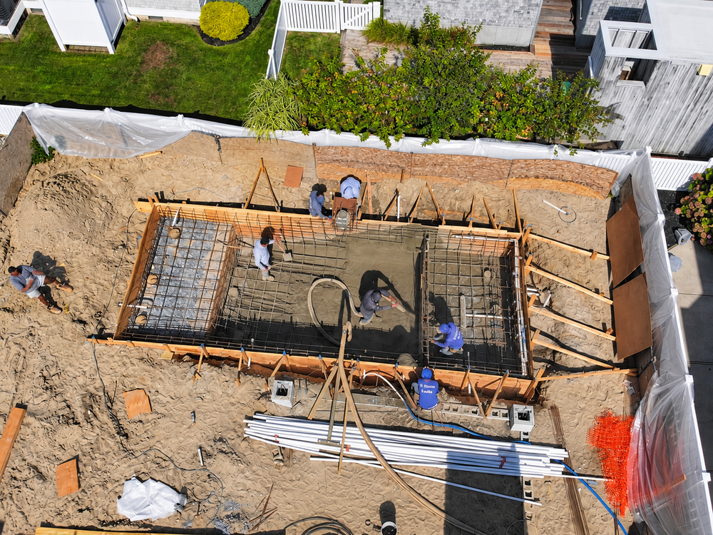Crew shooting gunite over a steel rebar pool shell in Longport, NJ