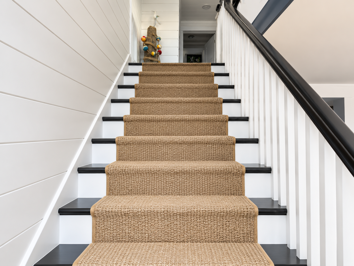 New staircase with a sisal runner and shiplap walls in the renovated Sea Isle City duplex