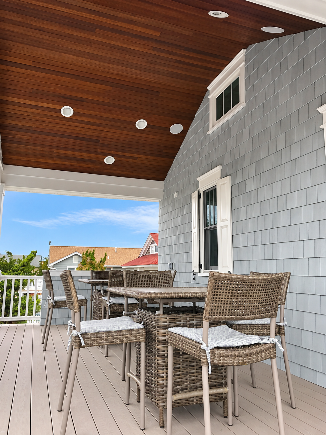 Covered porch with wood ceiling and outdoor dining, Stone Harbor NJ custom home
