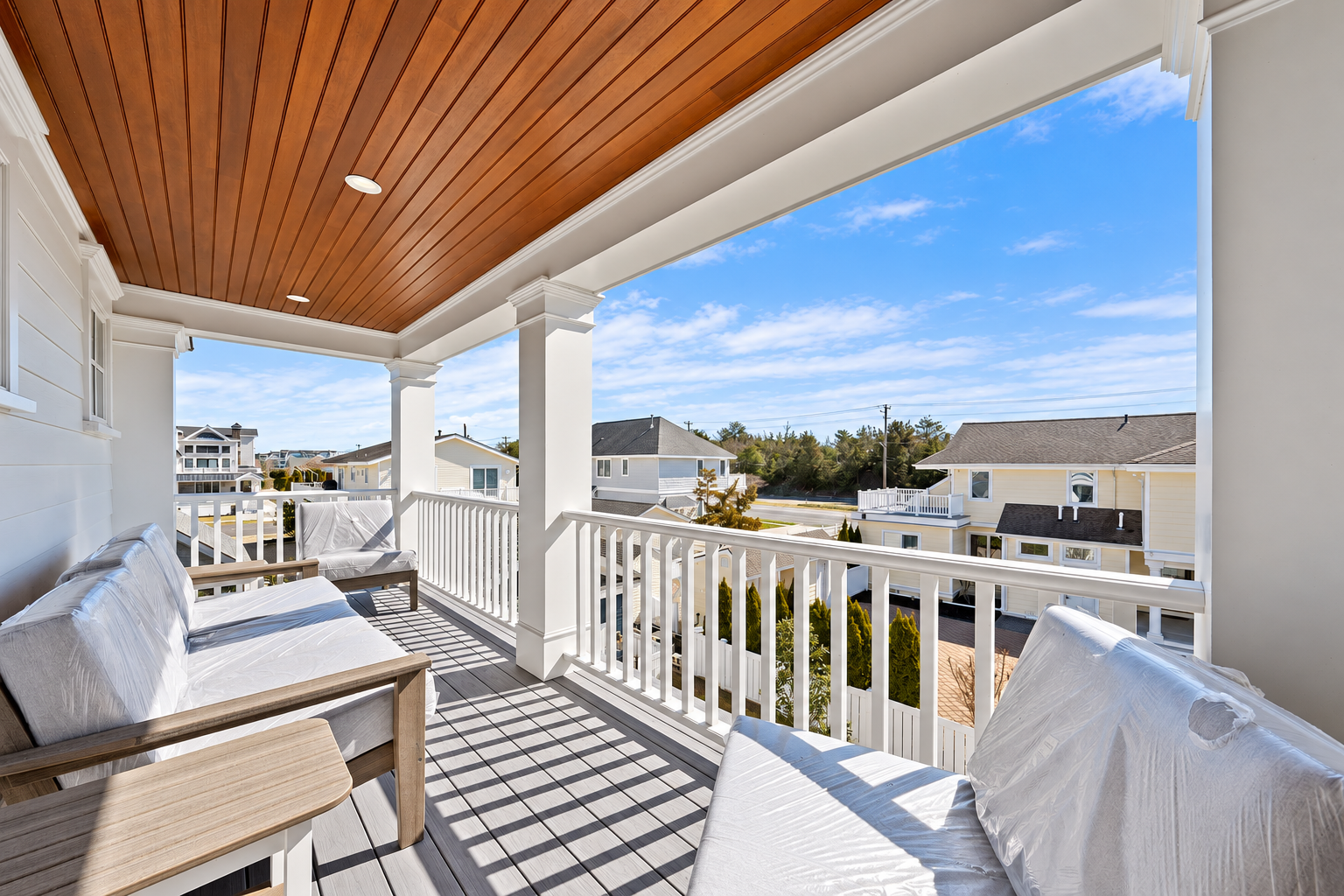 Covered deck with a wood ceiling and outdoor seating, 213 57th St, Avalon, NJ
