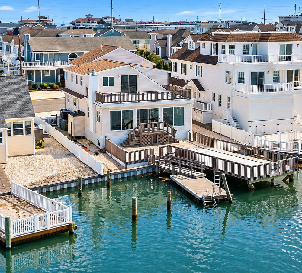 Before: the original bayfront house, sand yard and old docks at 7708 Sunset, Avalon, NJ