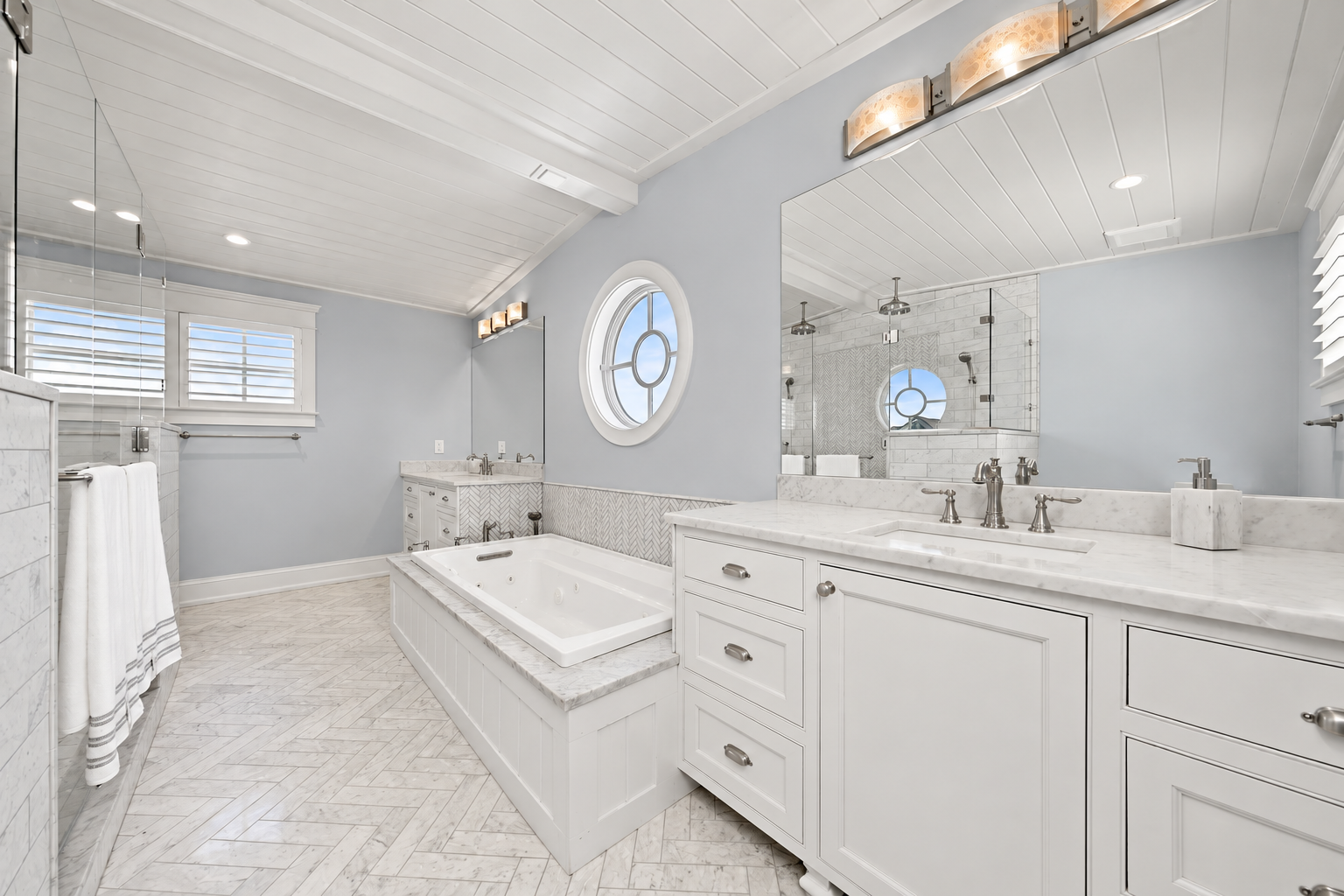 Primary bath with a Kohler whirlpool tub and double vanity, 213 57th St, Avalon, NJ