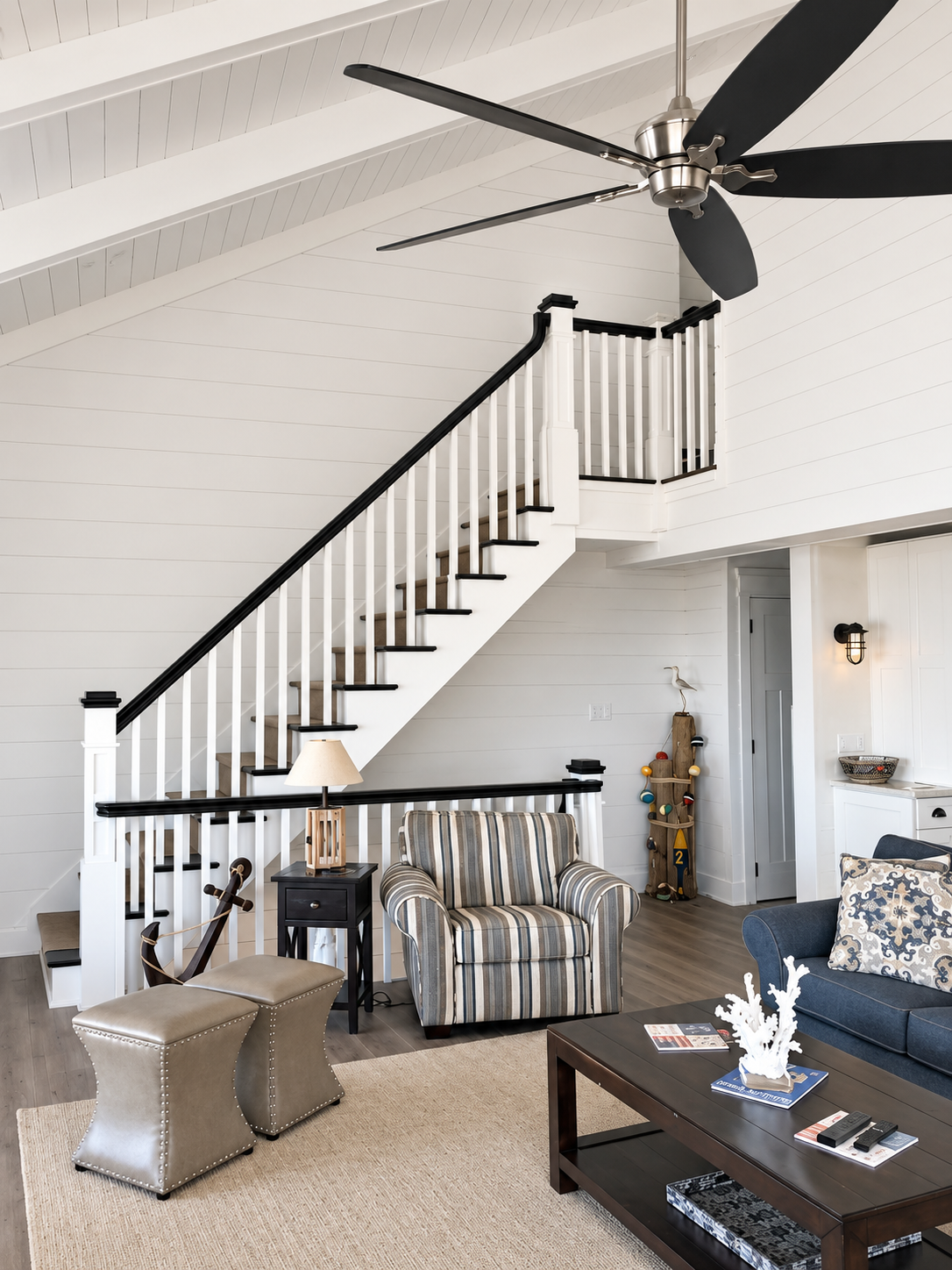 Living room and new staircase with white shiplap walls in the Sea Isle City duplex renovation
