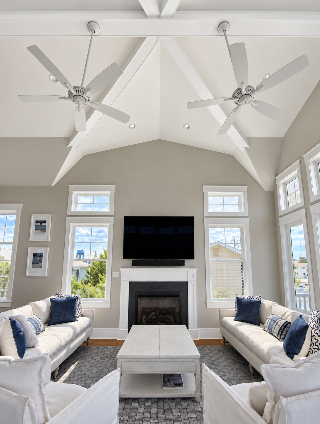 Vaulted living room with a fireplace and tall windows in a new Avalon, NJ custom home