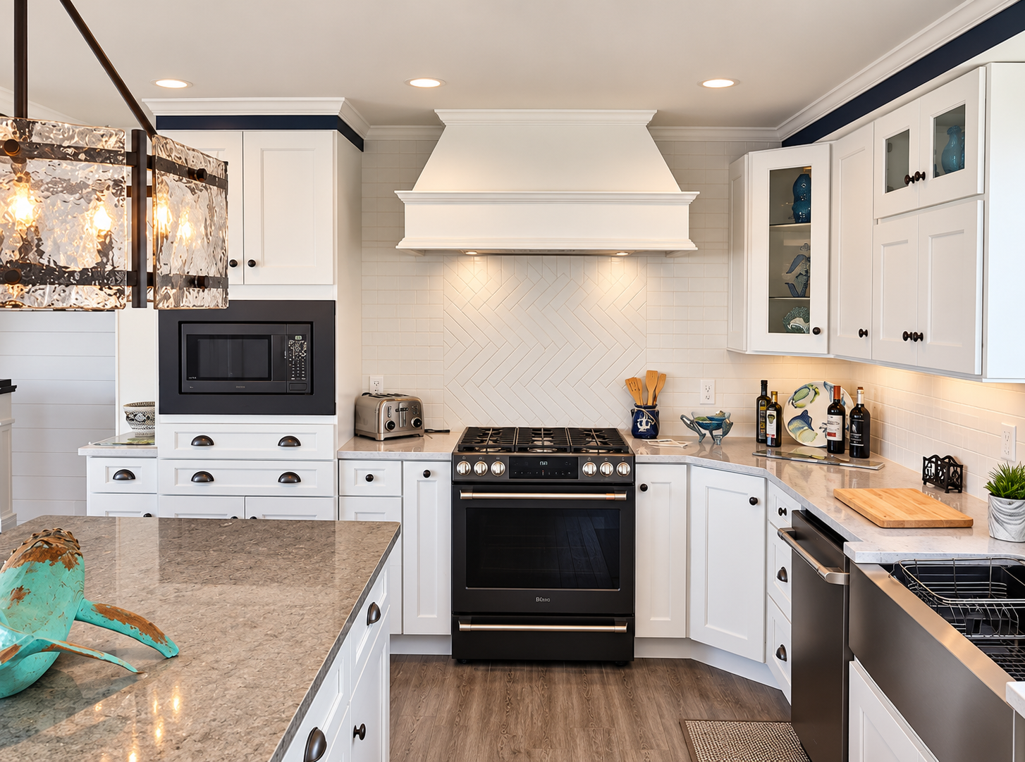New kitchen with a white range hood and tile backsplash in the renovated Sea Isle City duplex
