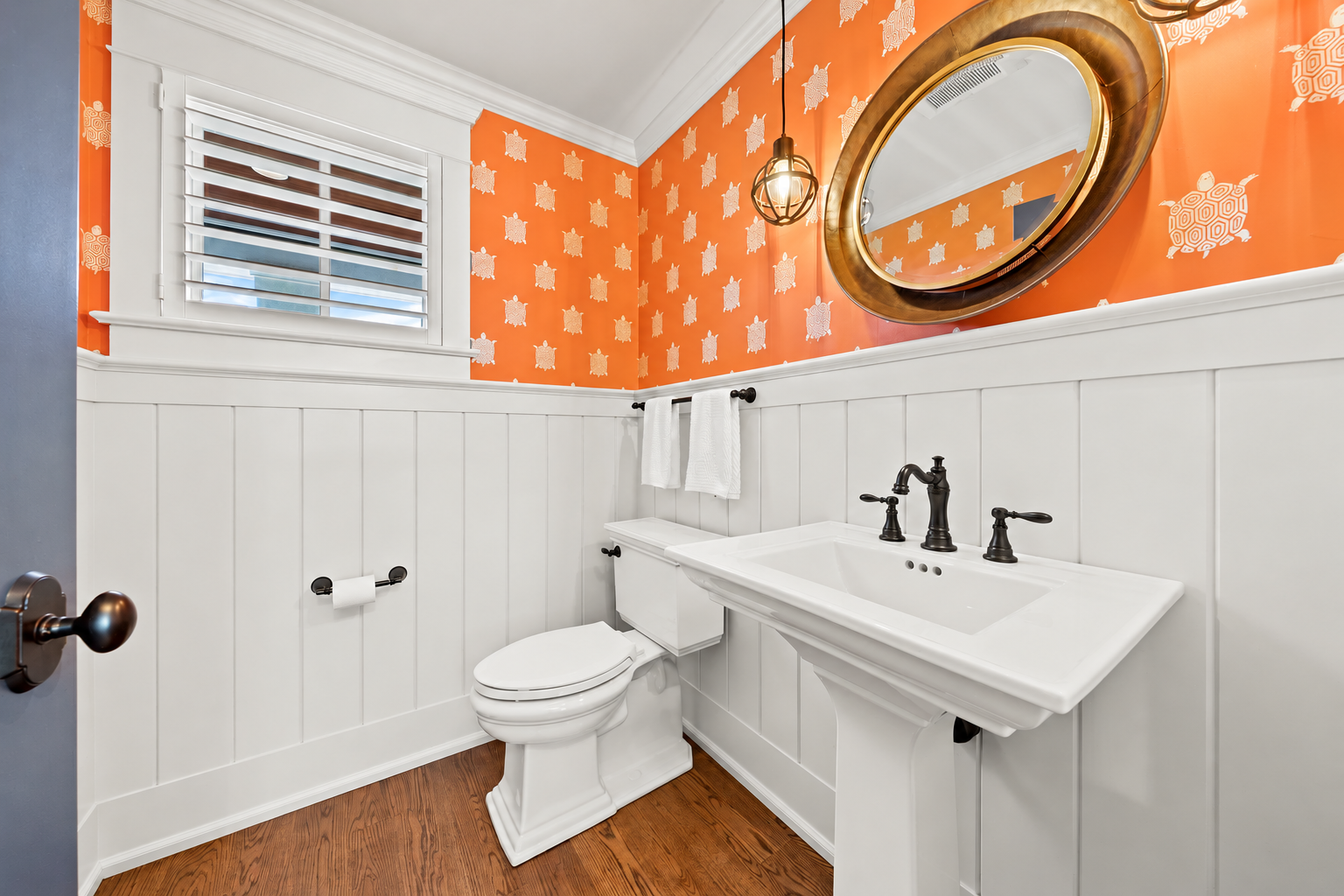 Powder room with sea turtle wallpaper and a round mirror, 213 57th St, Avalon, NJ