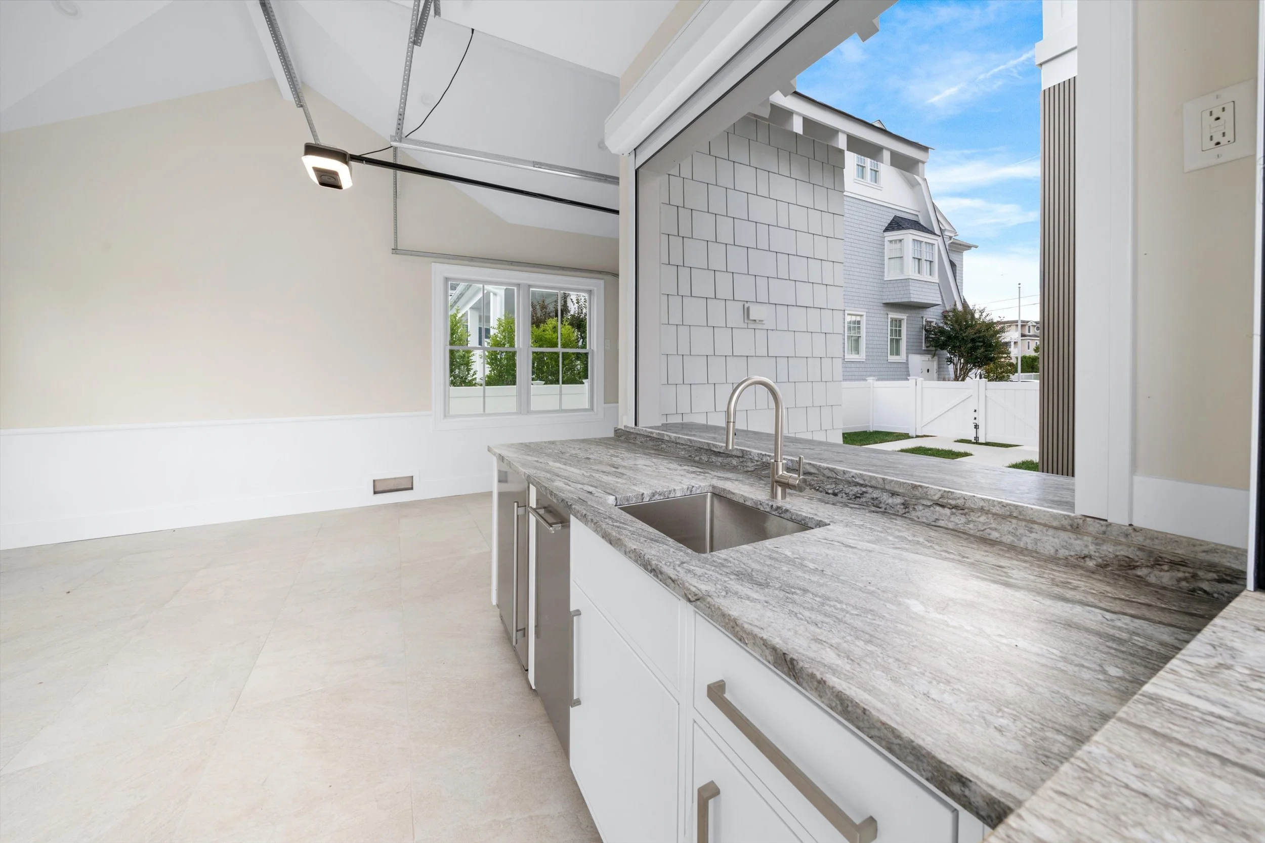 Pool cabana wet bar with a view out to the pool and spa, 245 57th St, Avalon, NJ
