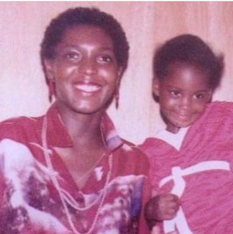 Photo taken in 1979 of a short haired radiant black woman and a cute little black girl leaning on the woman