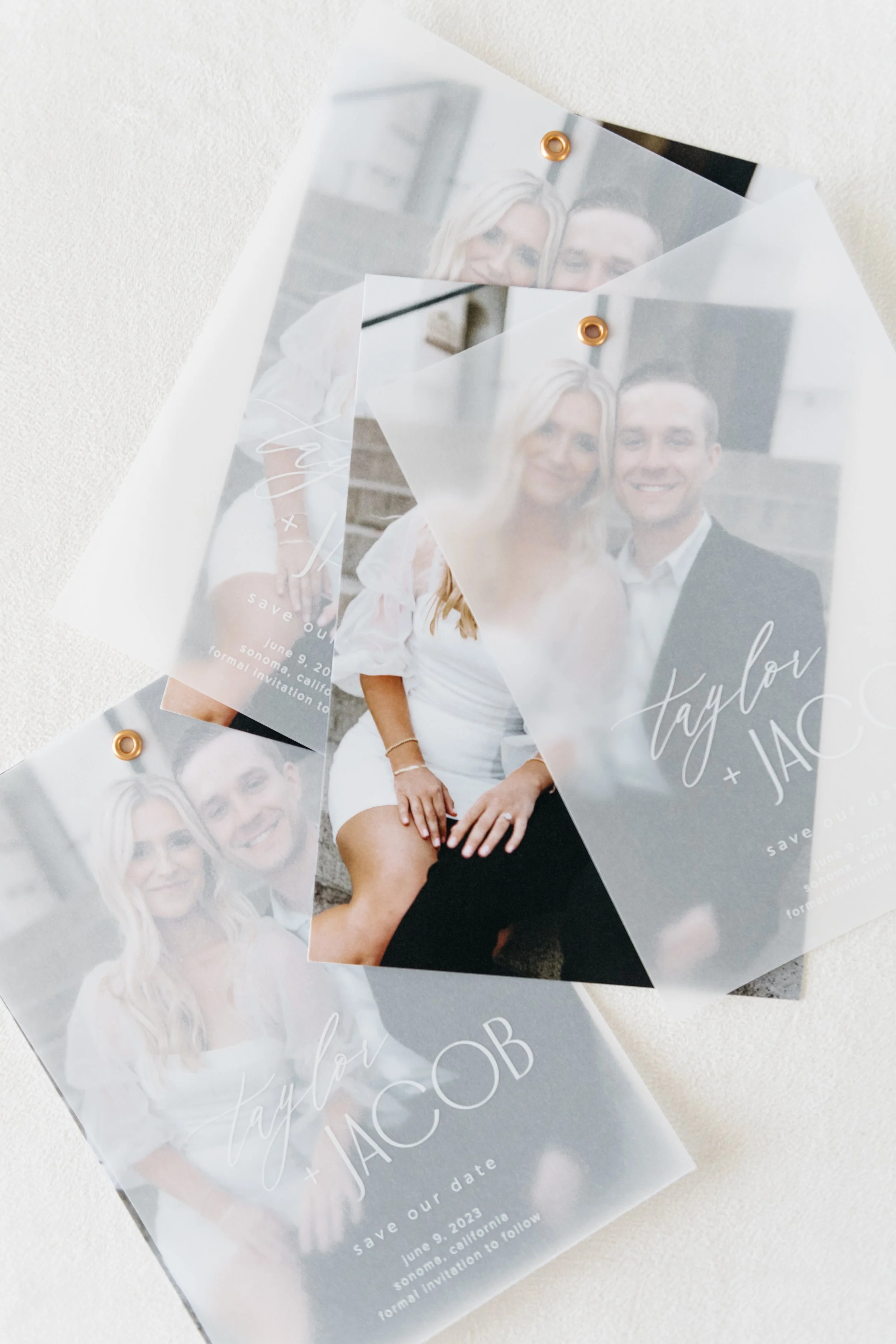 Wedding save-the-date cards featuring a seated couple, with translucent overlays and the text "Taylor + Jacob, save our date." Event details show June 9, 2023, in Sonoma, California.