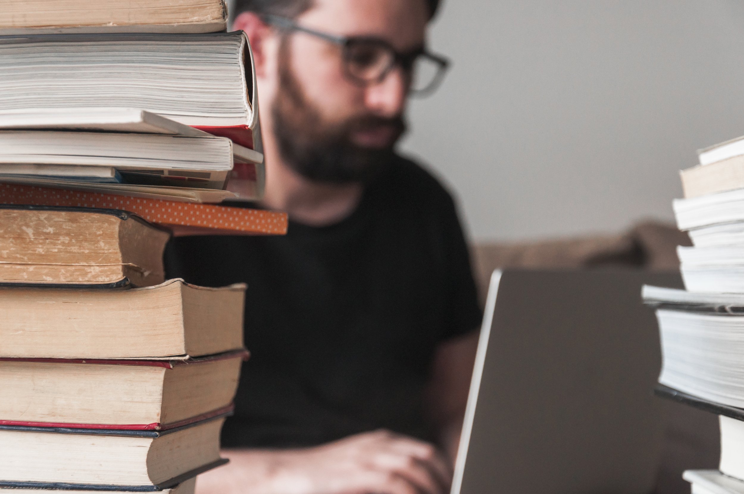 books-near-man-with-laptop.jpg
