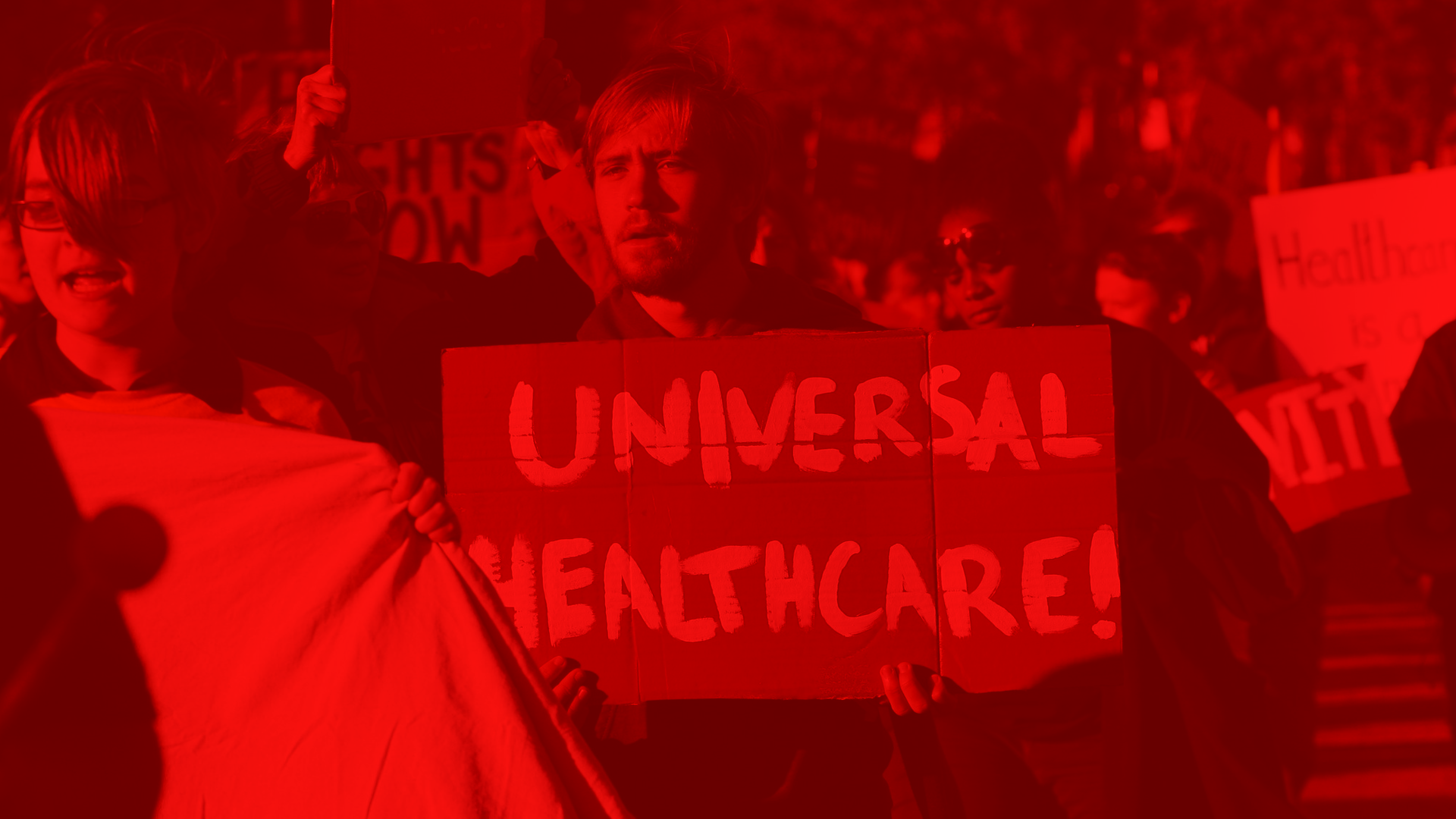People protesting for universal healthcare, holding signs at a rally with a red overlay.