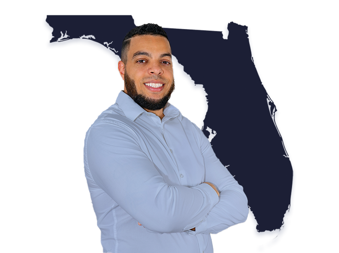 A man with a beard and short dark hair smiling with arms crossed, standing in front of an outline of the state of Florida.