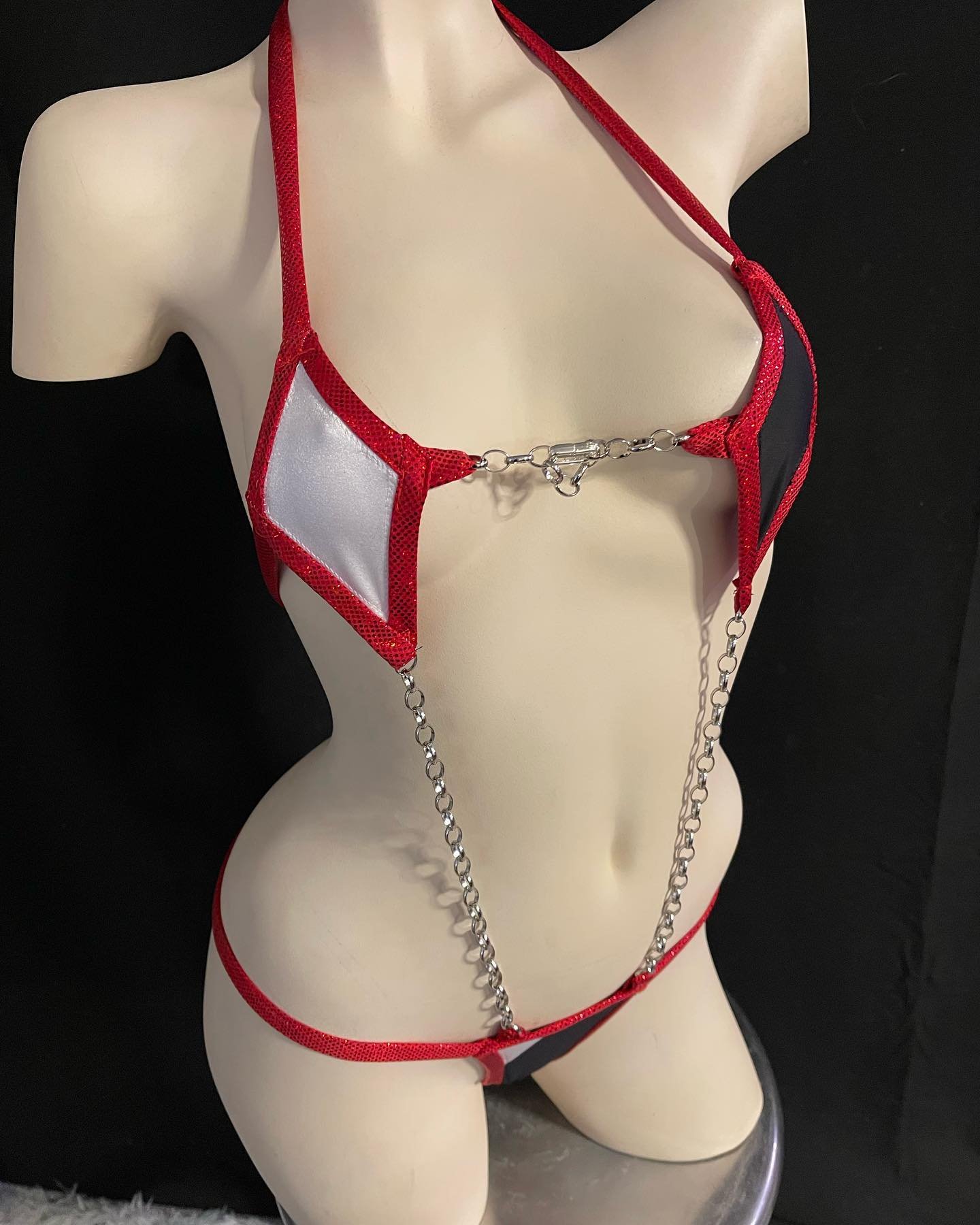 Mannequin wearing a red metallic bikini with chains
