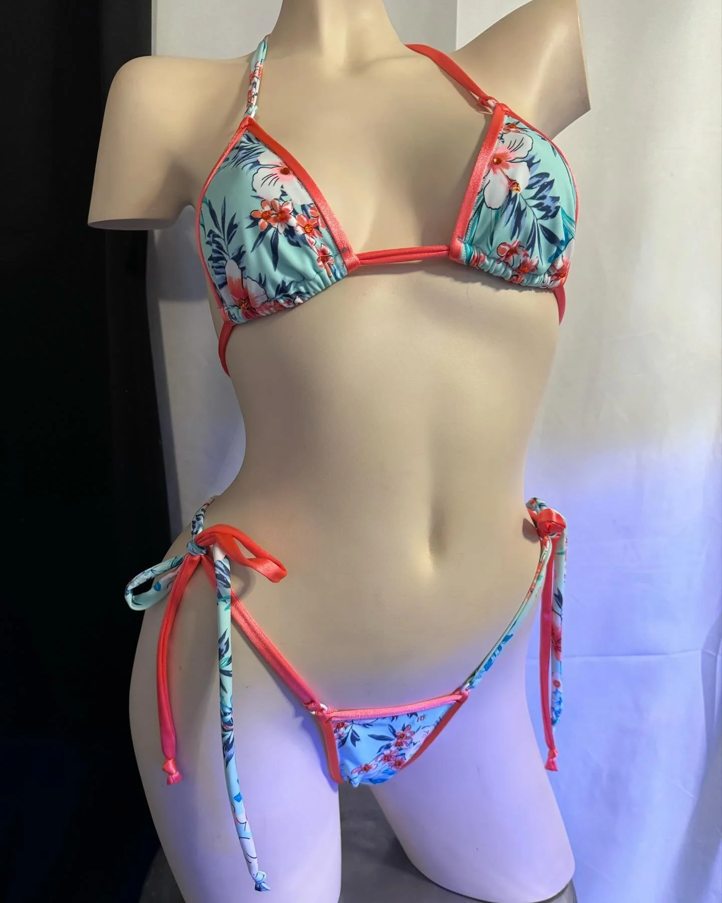 Mannequin wearing a floral bikini with red trim