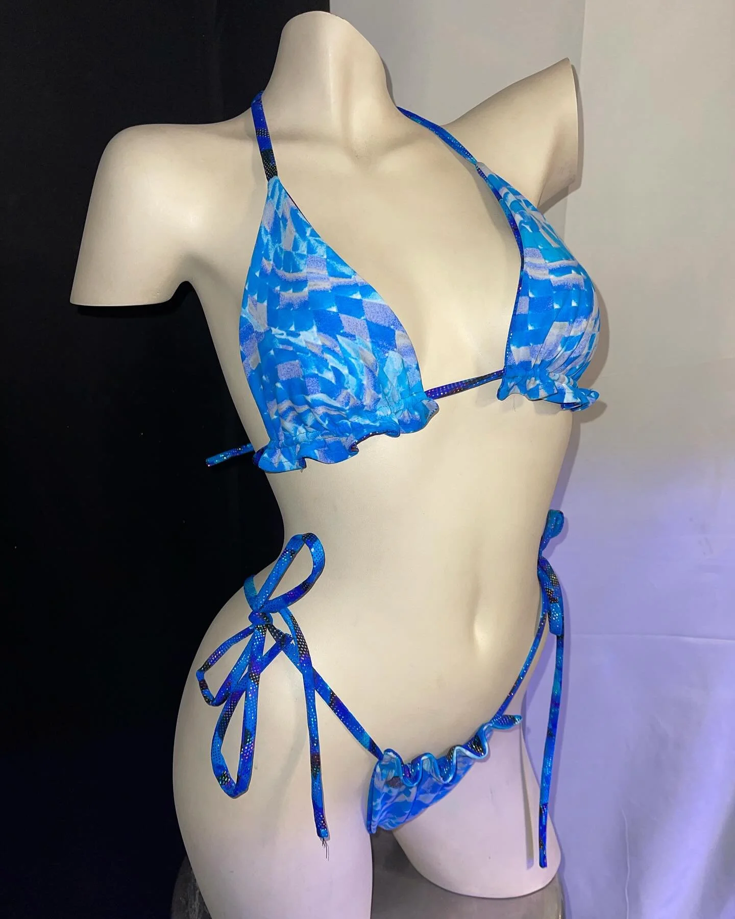 Mannequin wearing blue abstract print bikini with tie sides