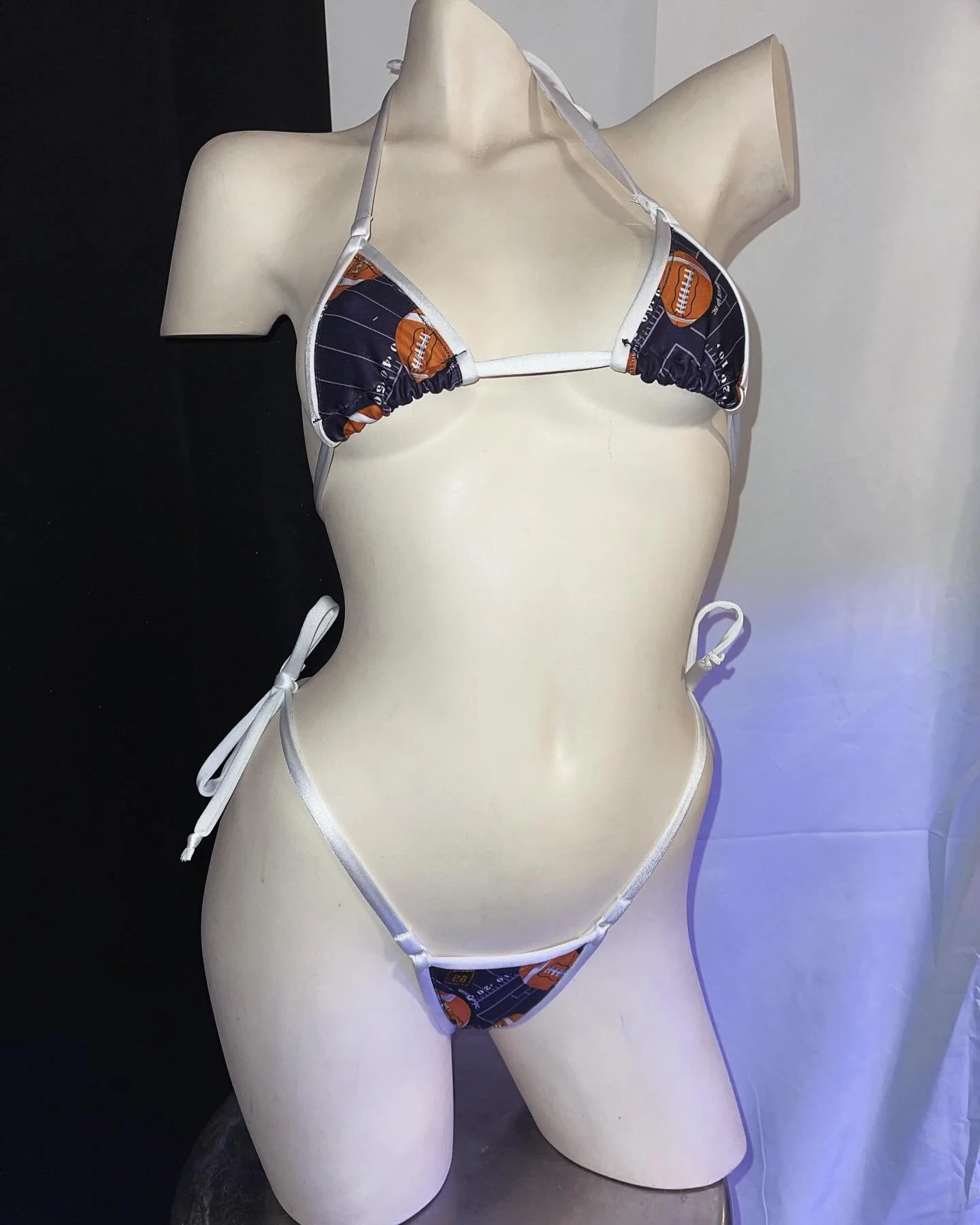 Mannequin wearing a football-themed bikini with white strings.