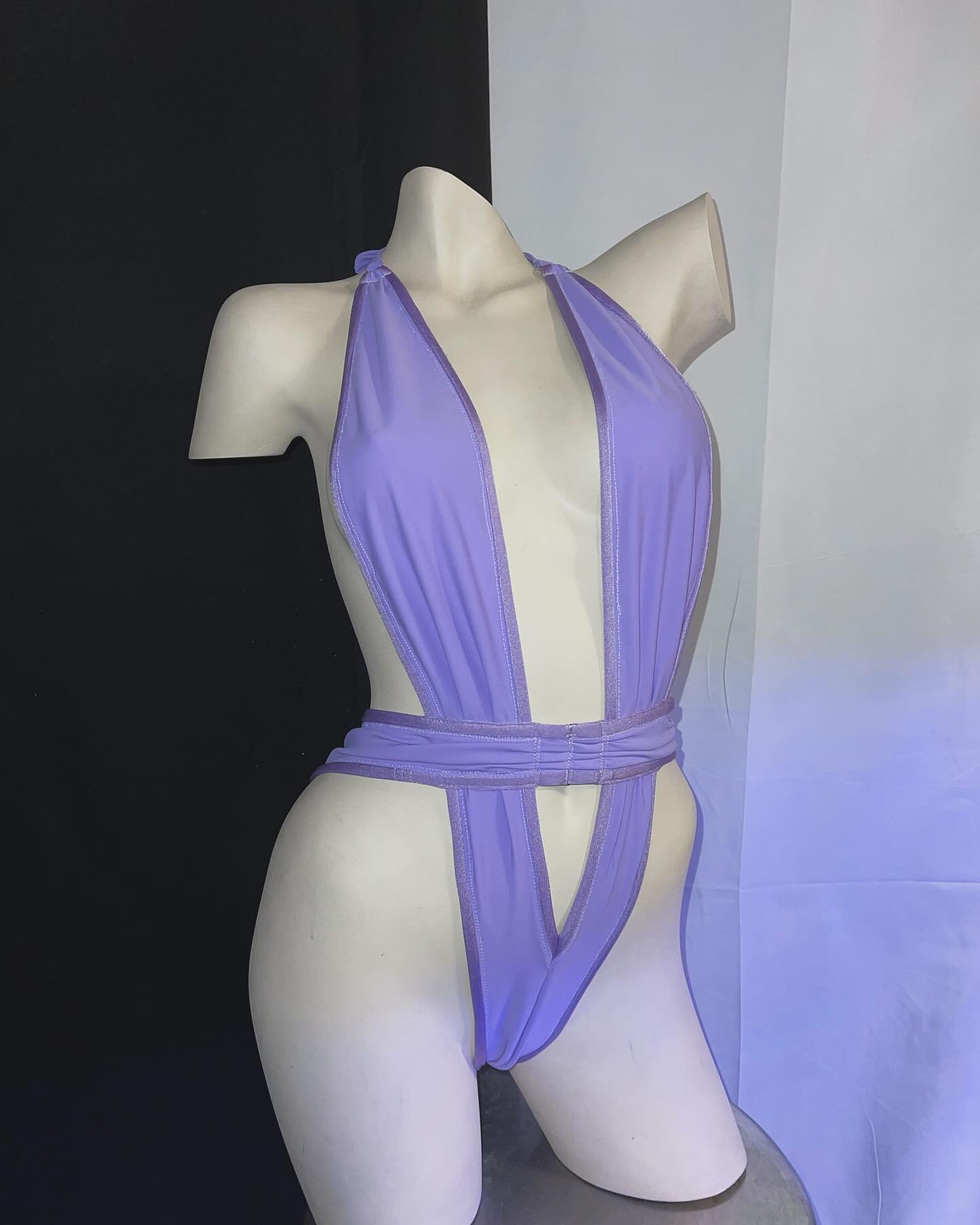 Mannequin wearing light purple one-piece swimsuit