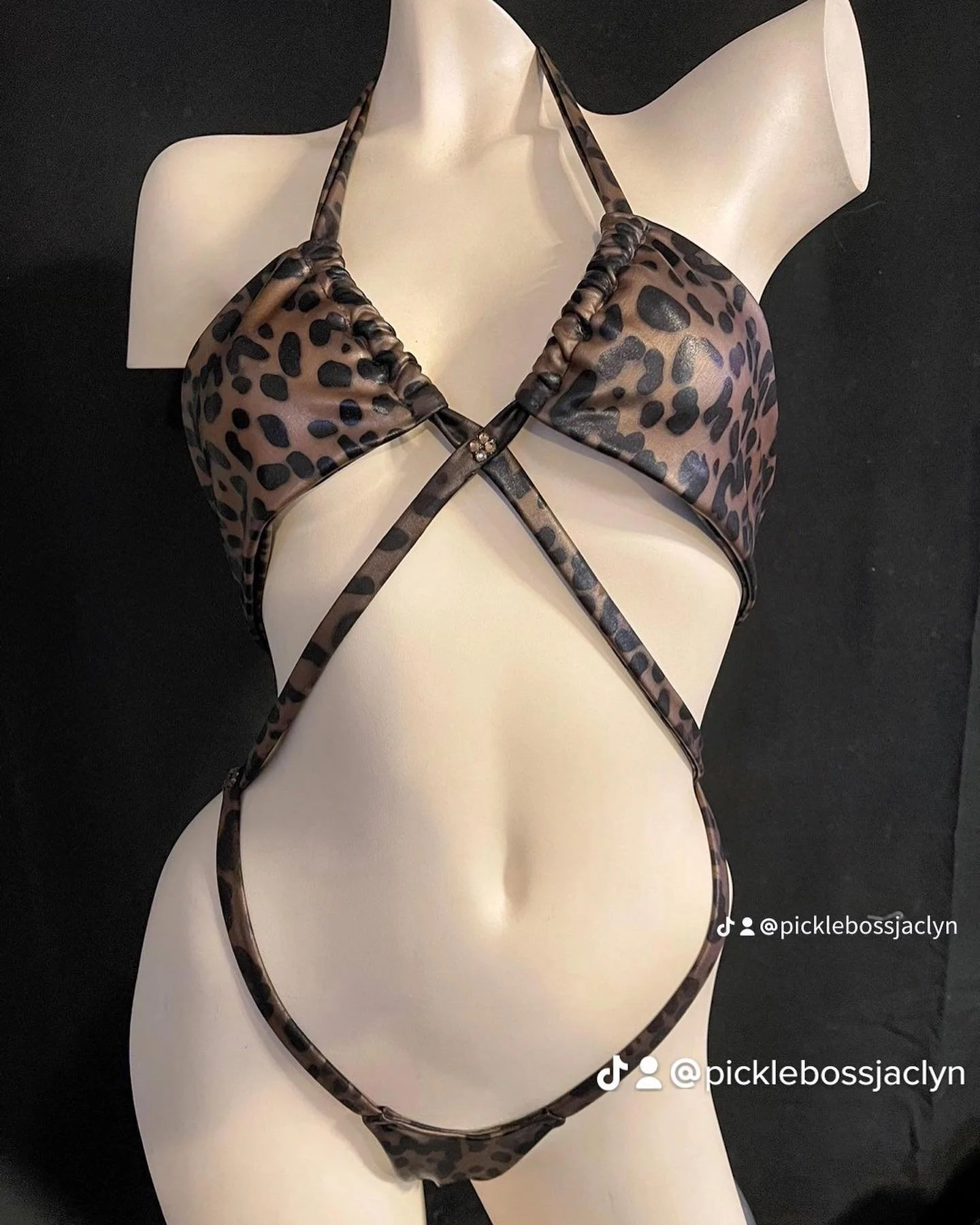 Leopard print strappy swimsuit on mannequin