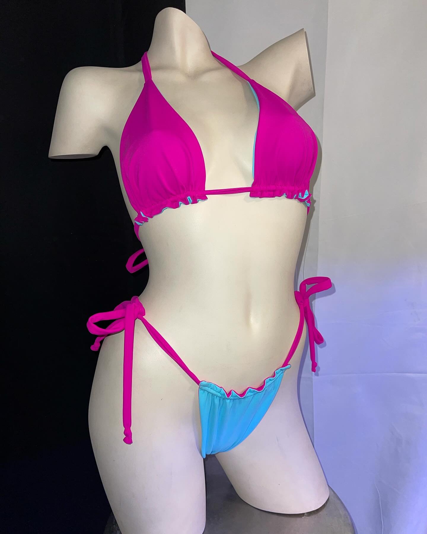 Mannequin wearing a pink and blue bikini