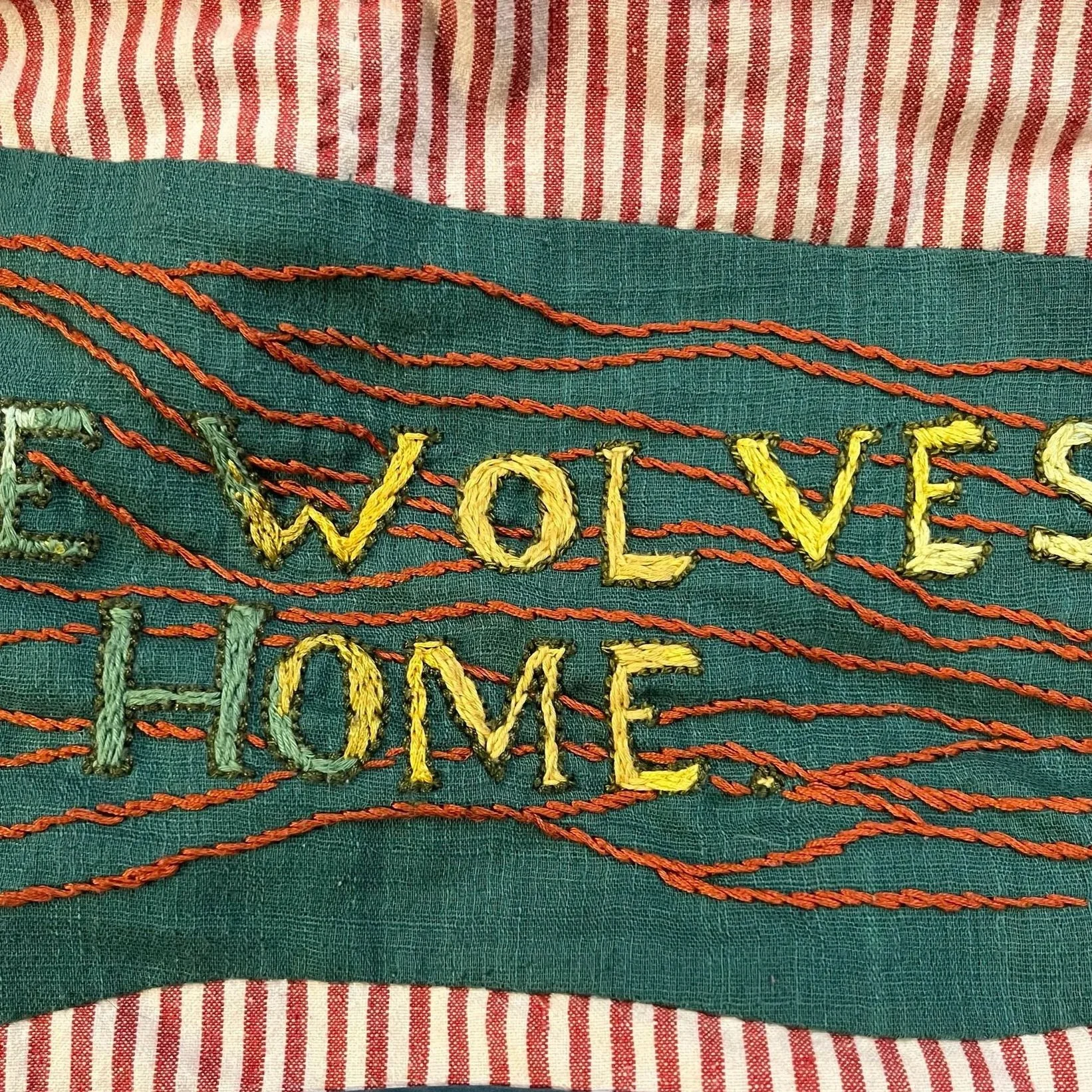 Patch on a quilt with embroidered lettering in ombre colors