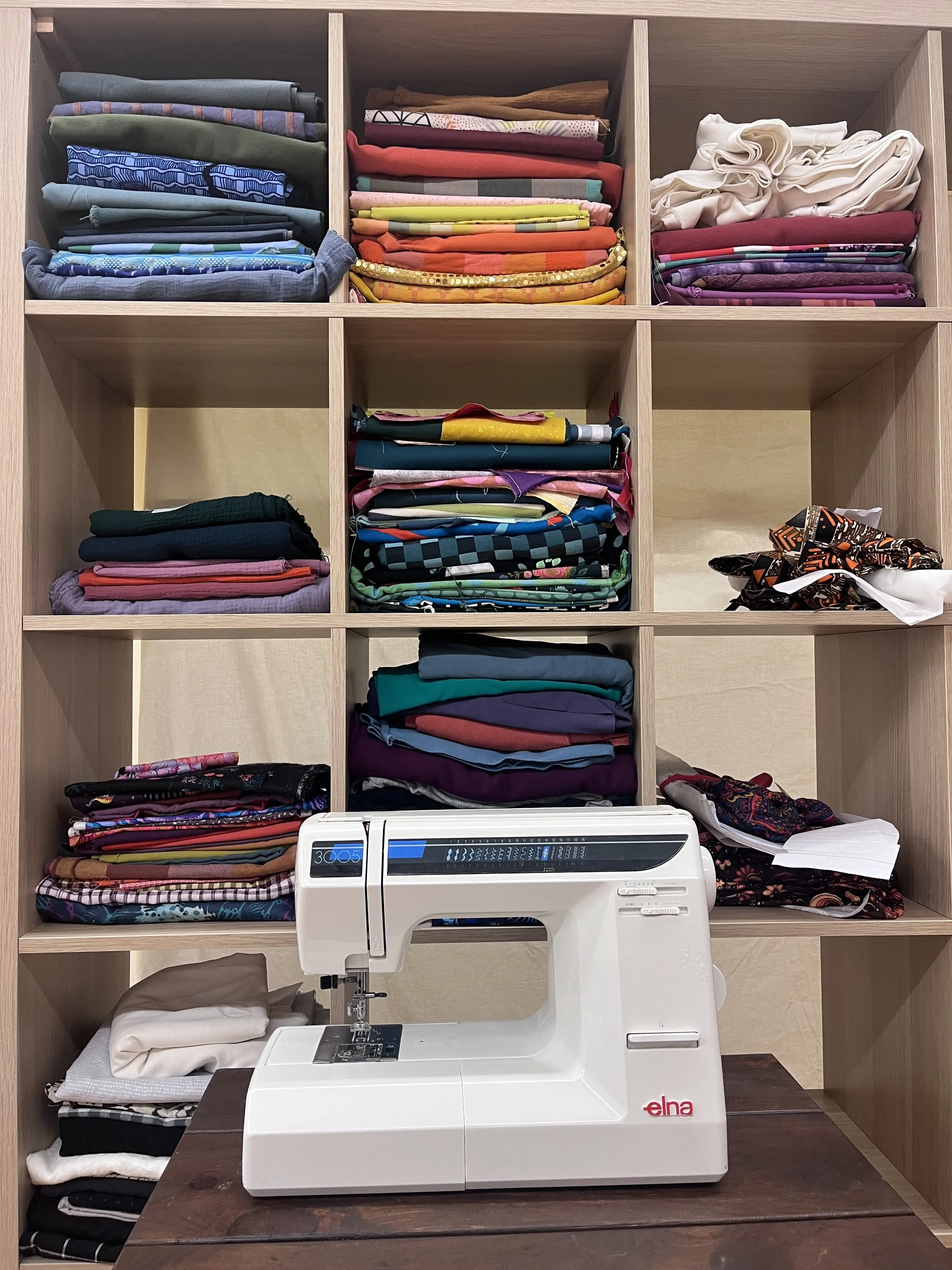 Fabric stash and student projects organized in a cubby system at the Grove House Sewing Studio