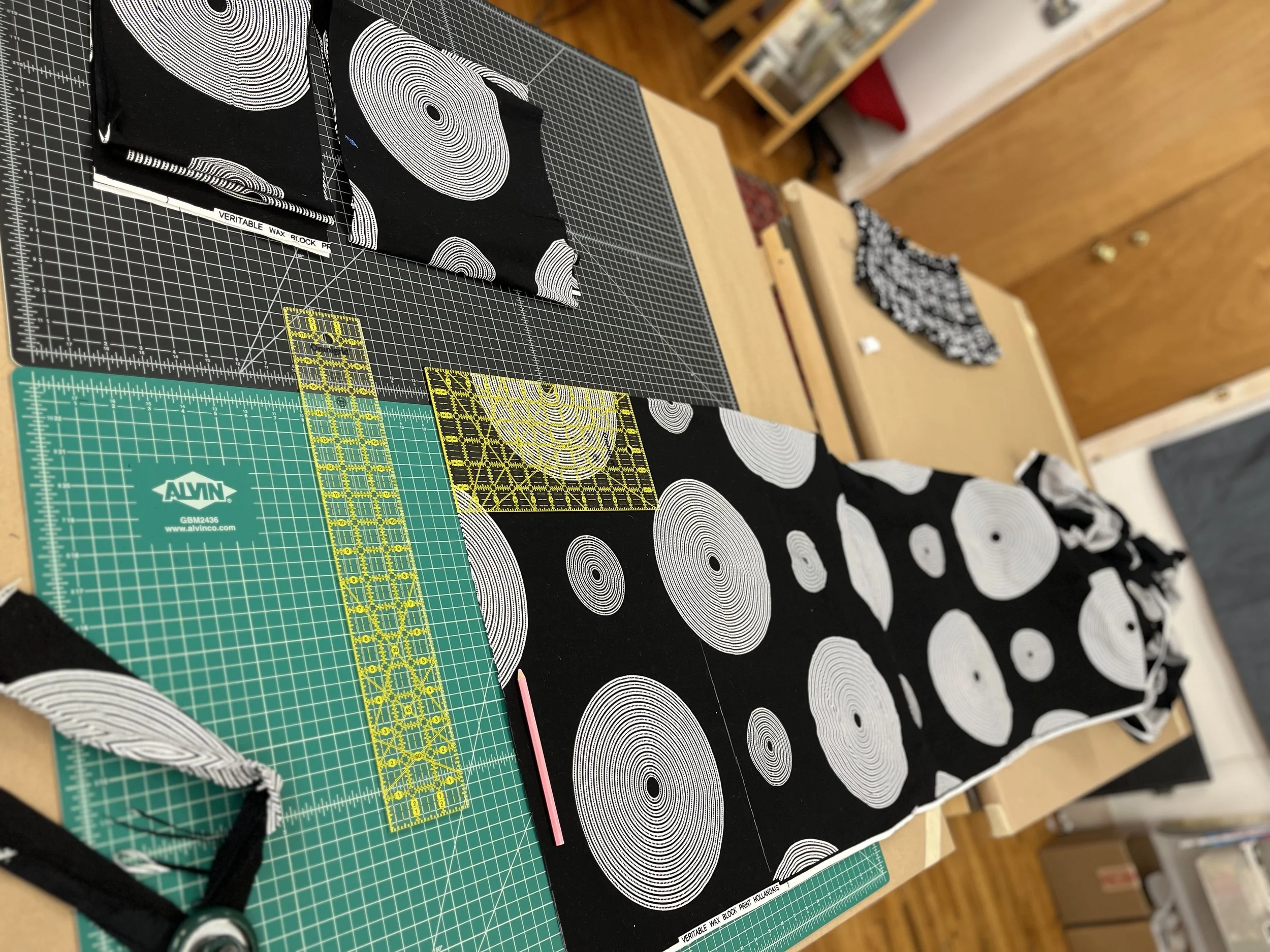 Using the big cutting tables for measuring and cutting long fabric pieces