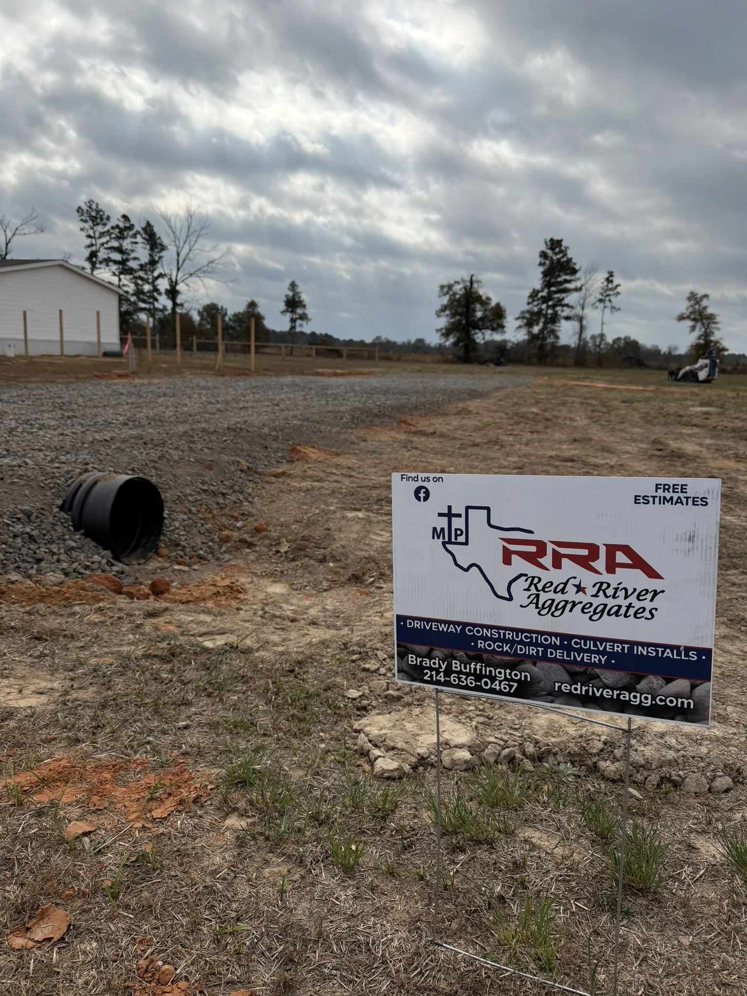 Driveway with culvert installed and company info sign