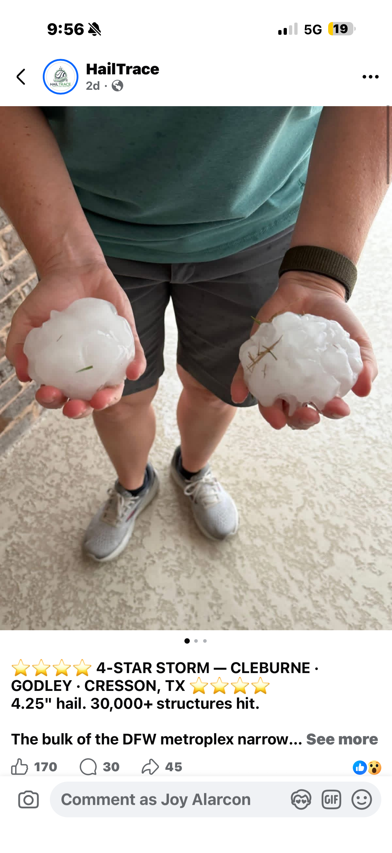 Person wearing gray shorts and a teal shirt holding two large hailstones, one in each hand, standing on a beige patterned floor.