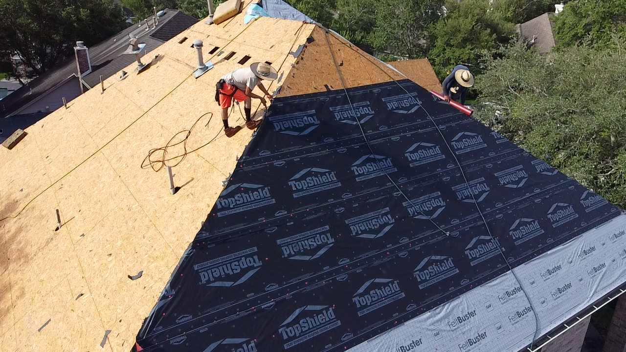 two roofers working on a re-roof