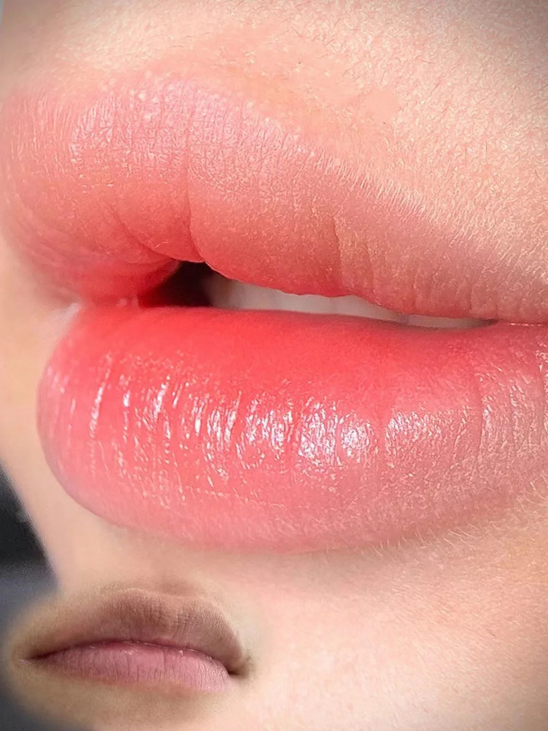 "Freshly done lip blush tattoo – soft pink tint for enhanced natural lip color."